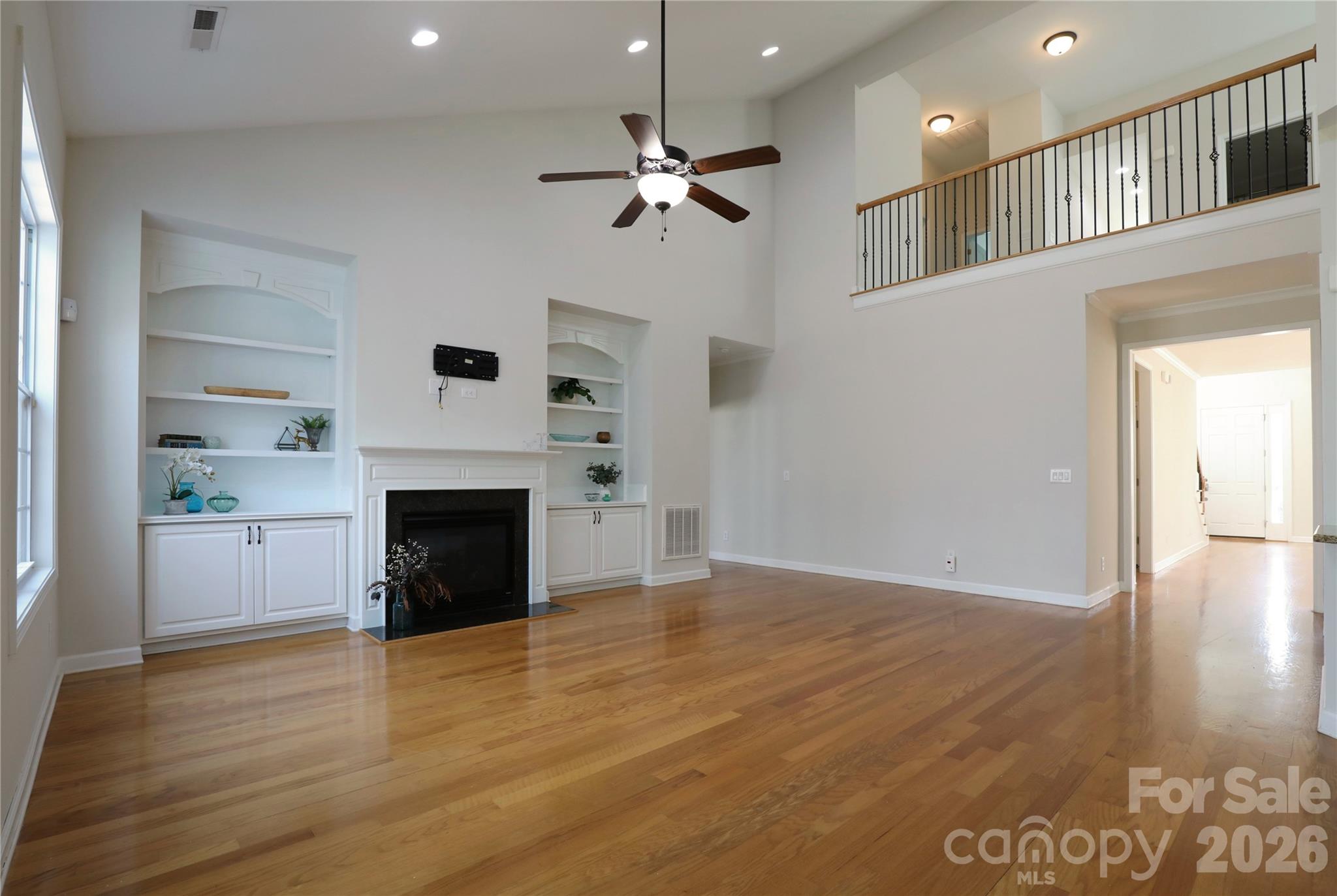 Welcoming great room centers the home and is open to kitchen and sunroom - 18465 E Marbella Lane, Fort Mill