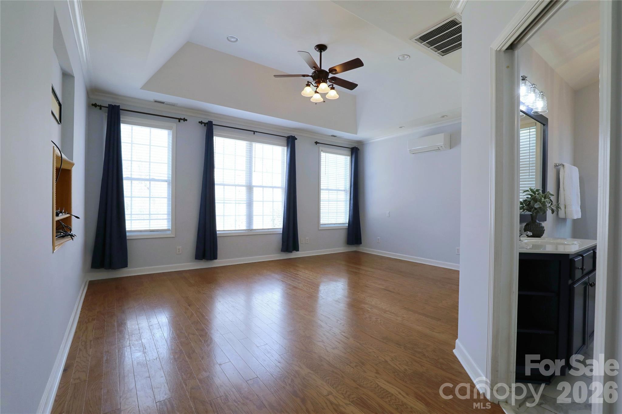 Primary bedroom on main level with trey ceiling and mini-split installed to allow comfort control to be isolated to this room. - 18465 E Marbella Lane, Fort Mill
