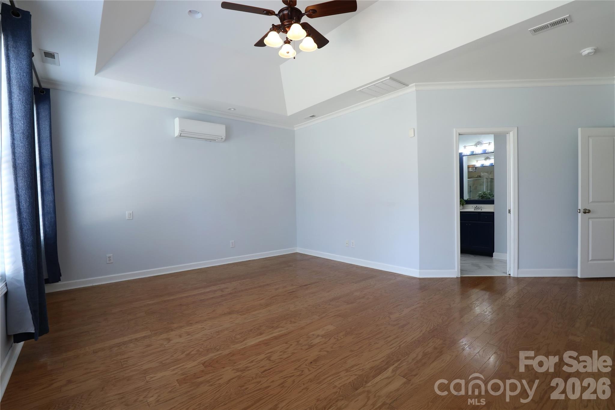 Primary bedroom on main level with trey ceiling and mini-split installed to allow comfort control to be isolated to this room. - 18465 E Marbella Lane, Fort Mill