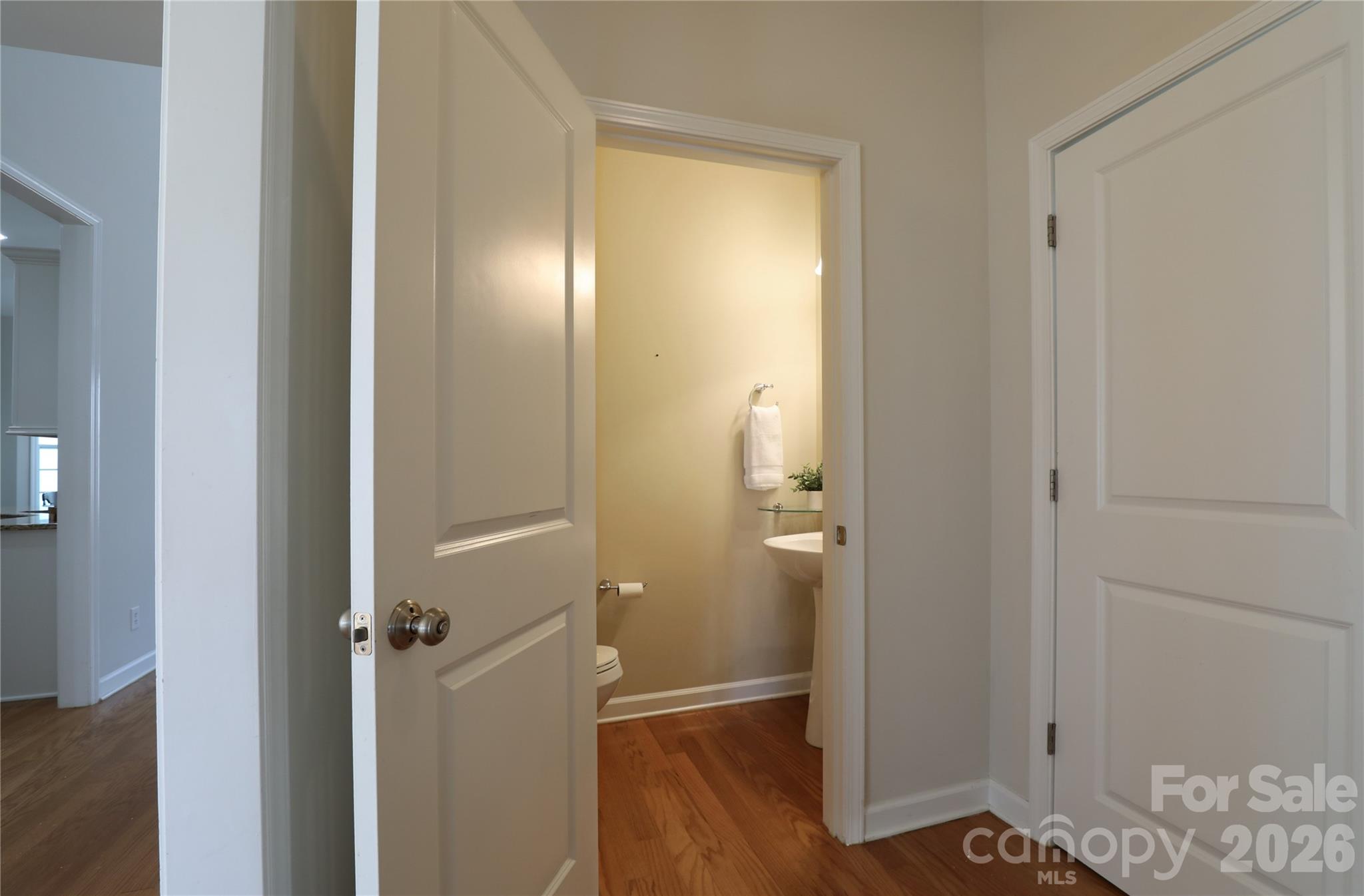Half bath on main level conveniently tucked near laundry and garage access. - 18465 E Marbella Lane, Fort Mill