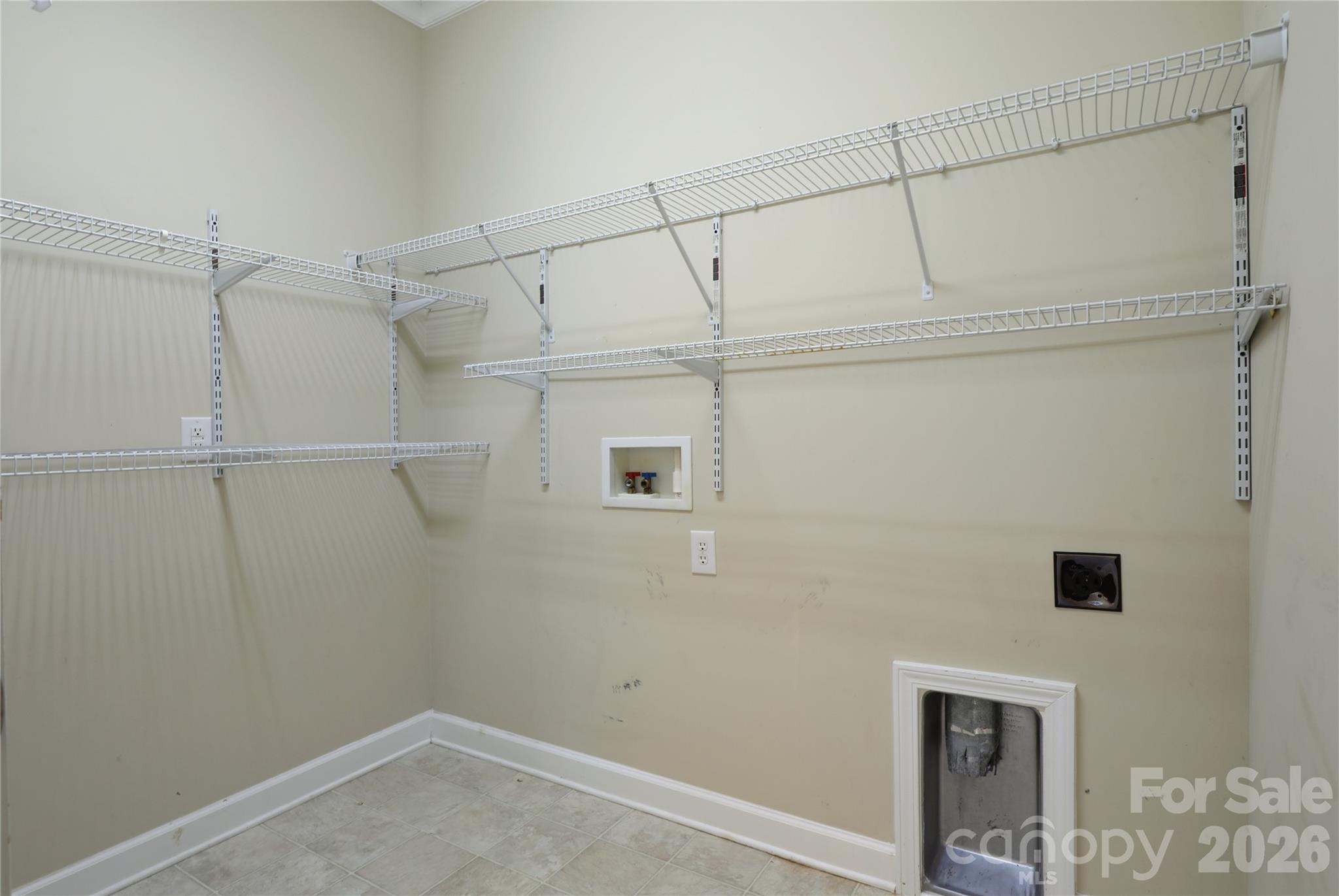 Main level laundry with shelving - 18465 E Marbella Lane, Fort Mill