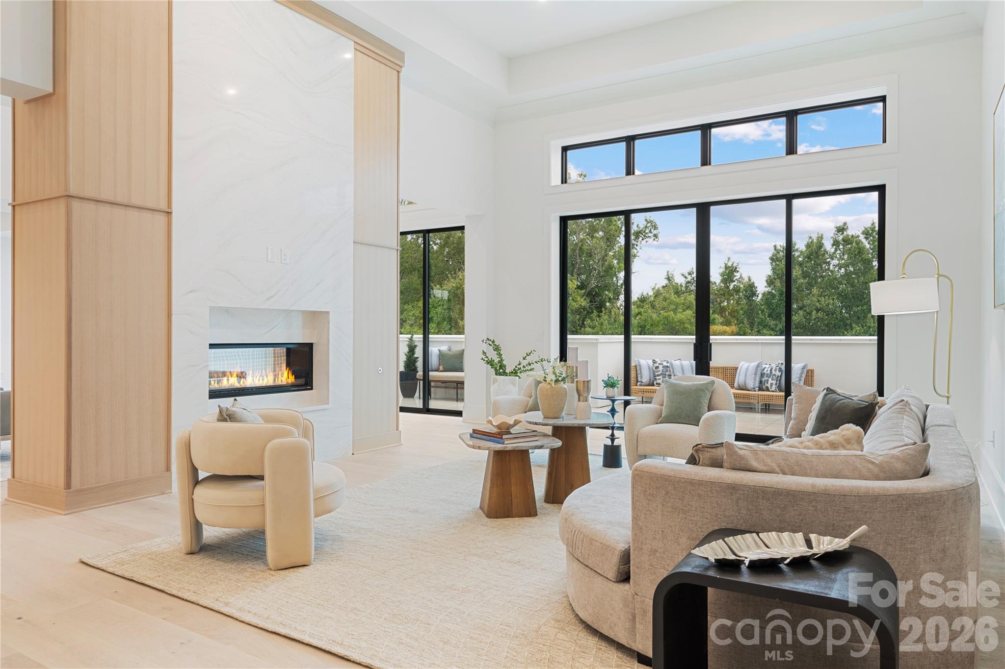 When entering #503, you step into a light-filled living space with exceptionally tall ceilings, oversized glass doors, treetop views and seamless access to the outdoor private terrace. - 409 Queens Road, Charlotte