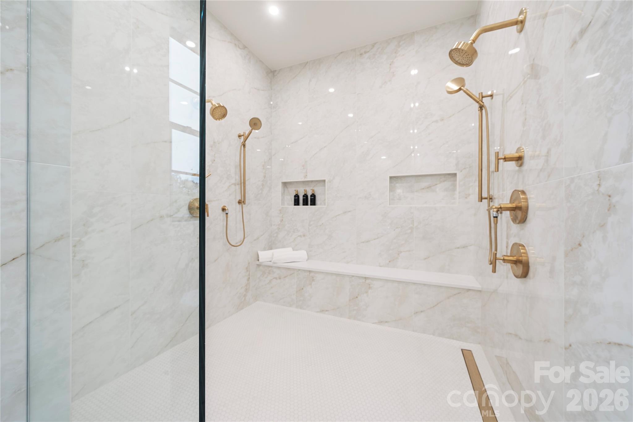 The oversized primary shower is marble, with dual shower systems, for your daily spa experience. - 409 Queens Road, Charlotte