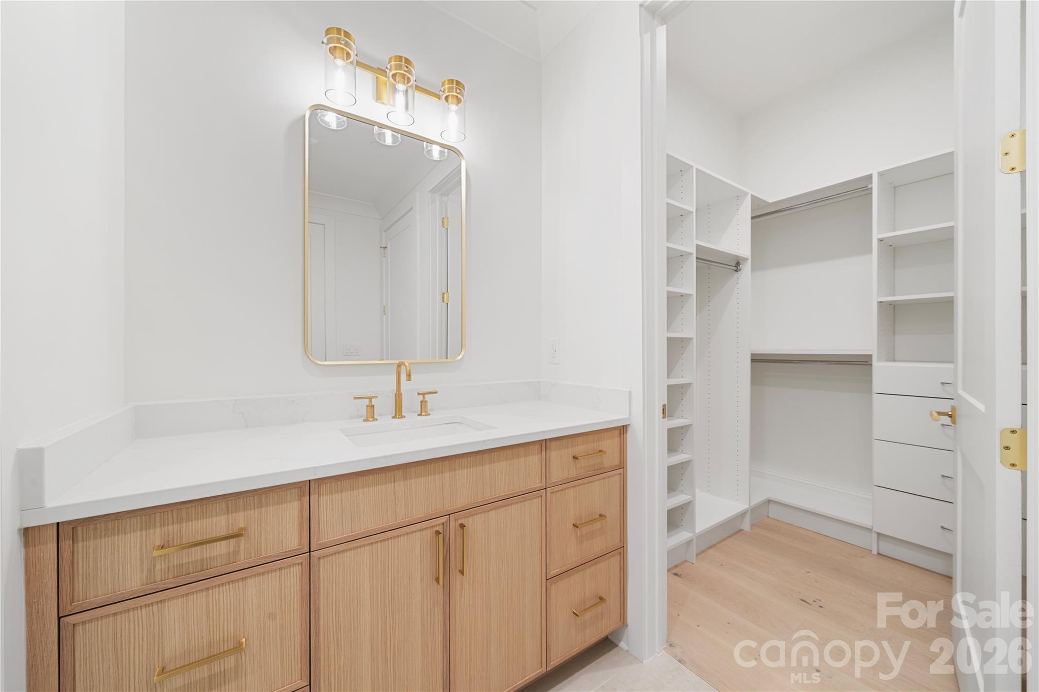 A view of the spacious walk-in closet with built-in storage that is part of Bedroom 3. - 409 Queens Road, Charlotte
