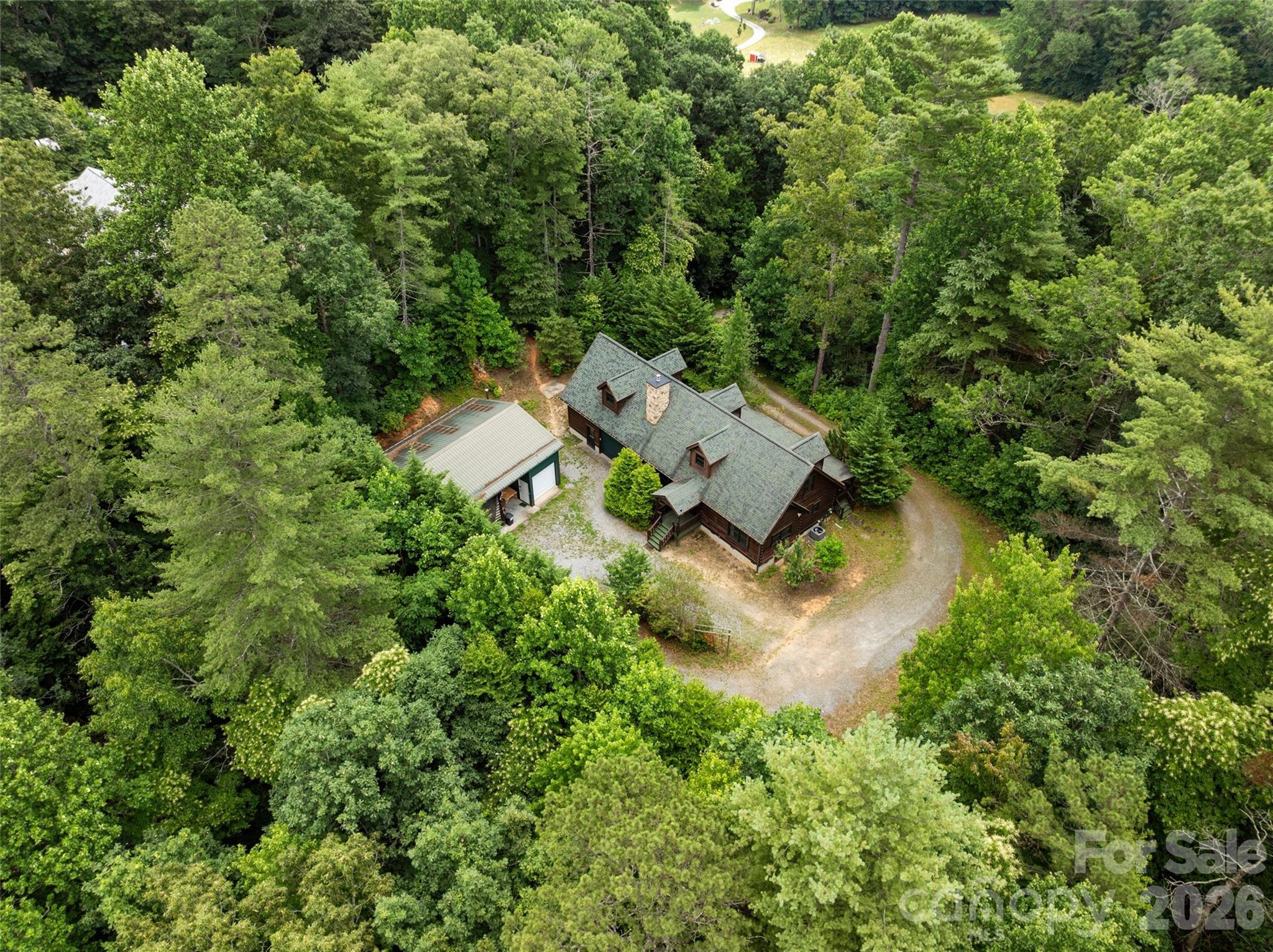 Perfectly positioned near the Henderson and Transylvania County line, this home offers the ultimate basecamp for Western North Carolina living. You can enjoy total mountain seclusion while retaining the ability to easily bounce between the vibrant downtowns of Hendersonville, Asheville, and Brevard within minutes. - 213 Big Valley Road, Pisgah Forest