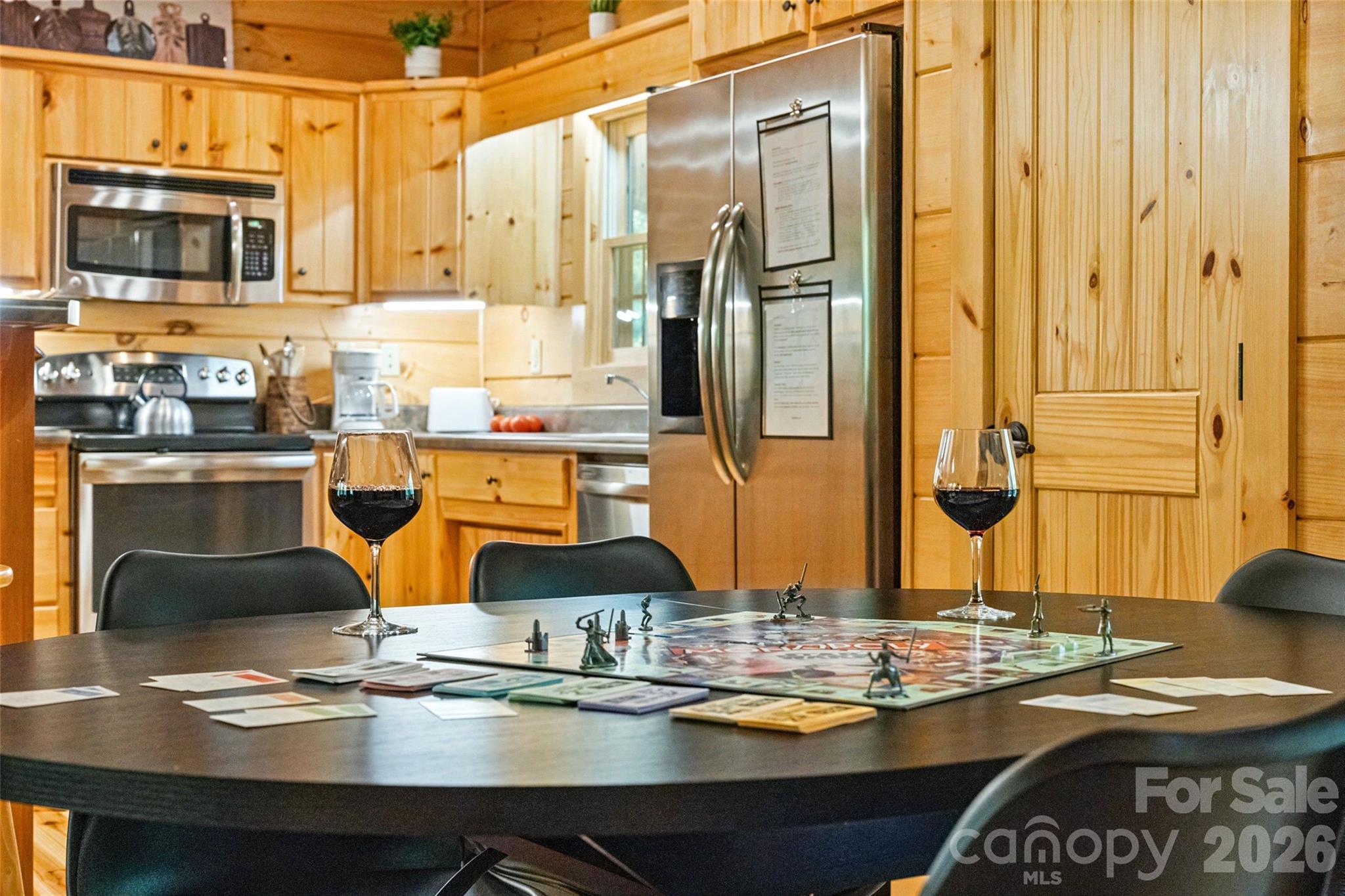 Set the scene for unforgettable mountain evenings. The dedicated dining space is perfect for hosting lively board game nights or enjoying a relaxing glass of wine while dinner simmers in the adjacent, fully-equipped kitchen. - 213 Big Valley Road, Pisgah Forest