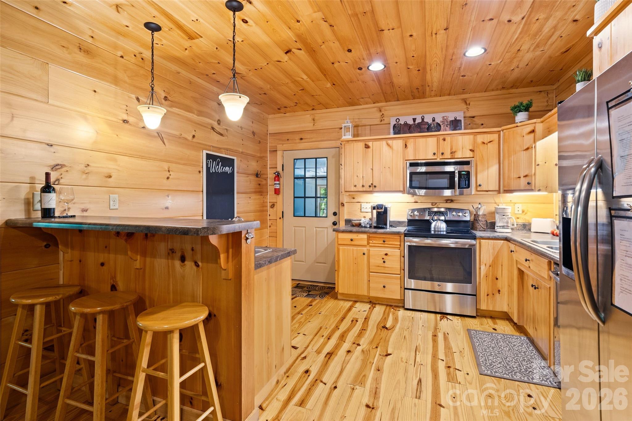 Bar seating in the kitchen. - 213 Big Valley Road, Pisgah Forest