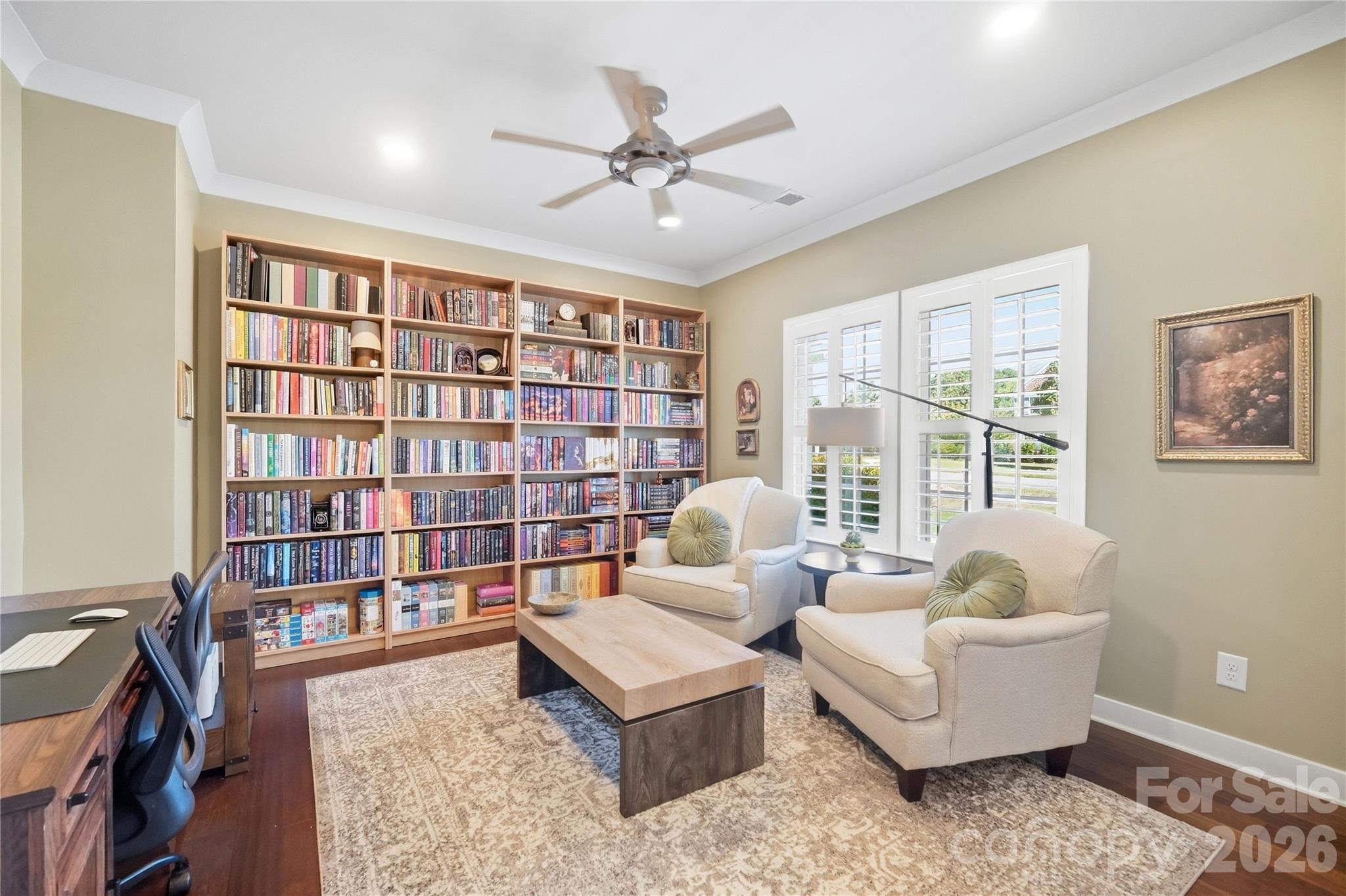 One of two main-level office spaces, with plantation shutters, a ceiling fan, and recessed lighting. Room for a desk and a comfortable sitting area. - 912 Manorwood Drive, Waxhaw