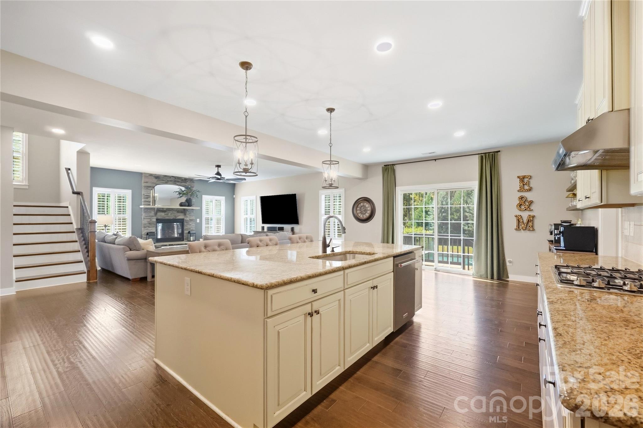 The island opens to the breakfast area and family room, with a sliding glass door to the back deck. - 912 Manorwood Drive, Waxhaw