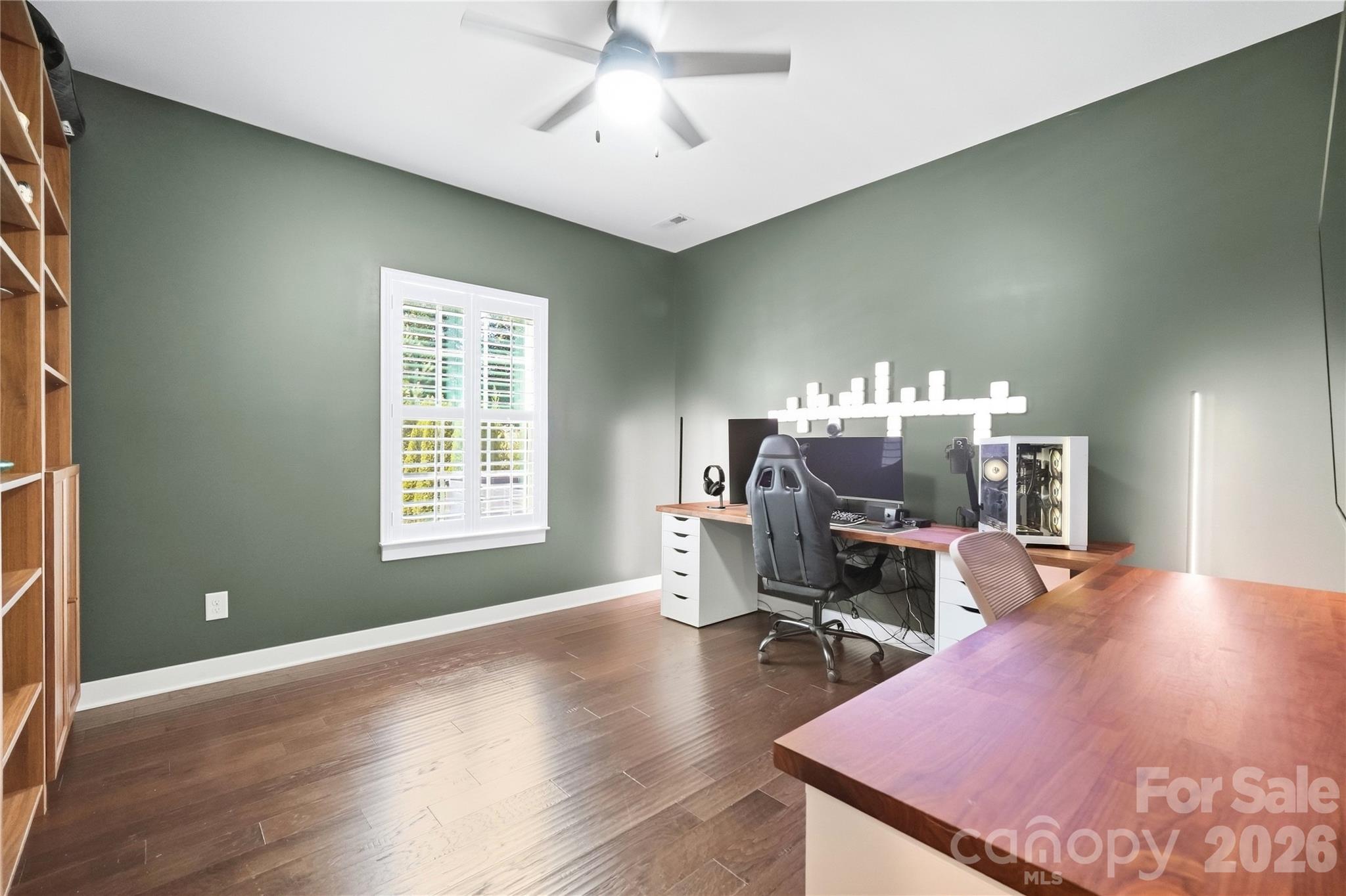 Flexible main-level study with plantation shutters and a ceiling fan, ready to work as a second home office, guest space, or workout room. - 912 Manorwood Drive, Waxhaw