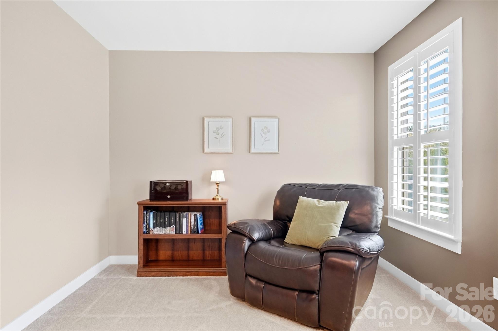 Sitting area in the primary suite, a quiet spot for reading, a morning coffee, or a small workspace. - 912 Manorwood Drive, Waxhaw