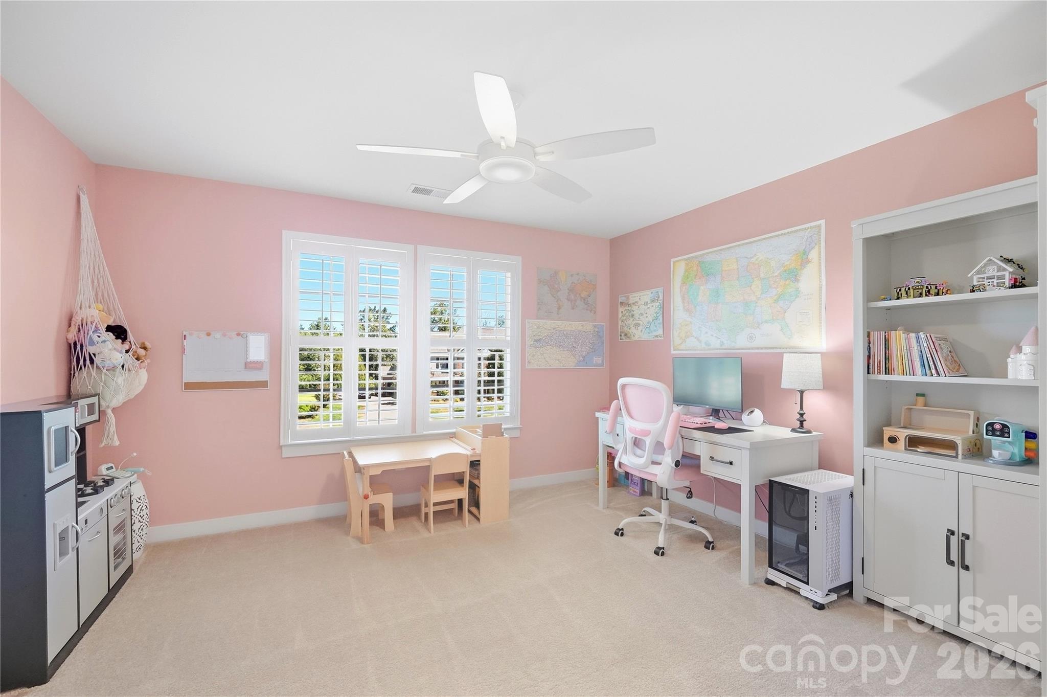 Bedroom 3 with a double window, plantation shutters, and a ceiling fan. - 912 Manorwood Drive, Waxhaw