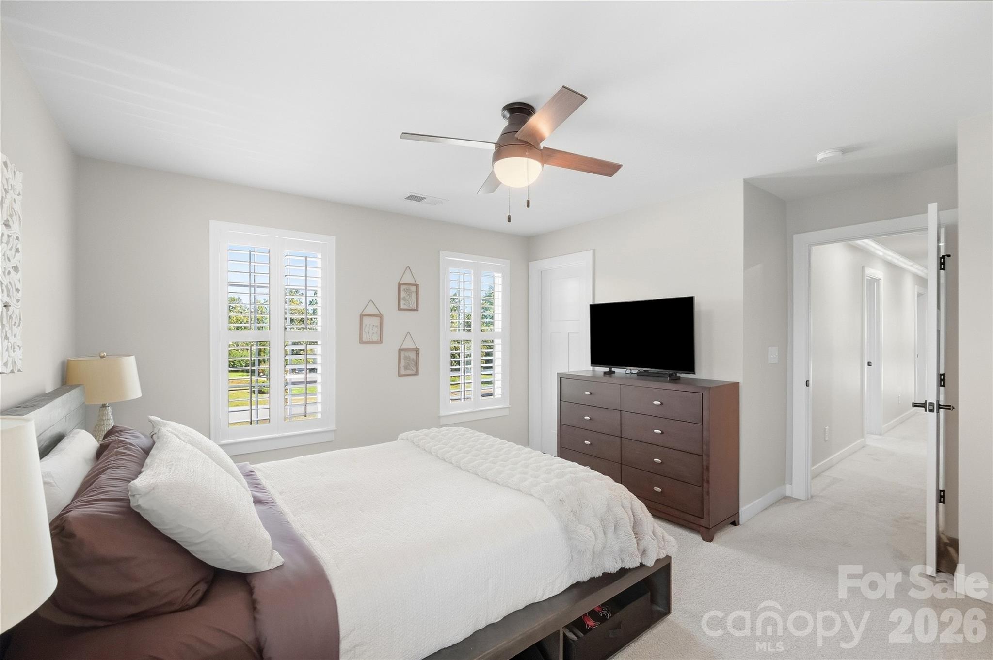 Bedroom 4 sits at the end of the hallway and has a walk-in closet. - 912 Manorwood Drive, Waxhaw