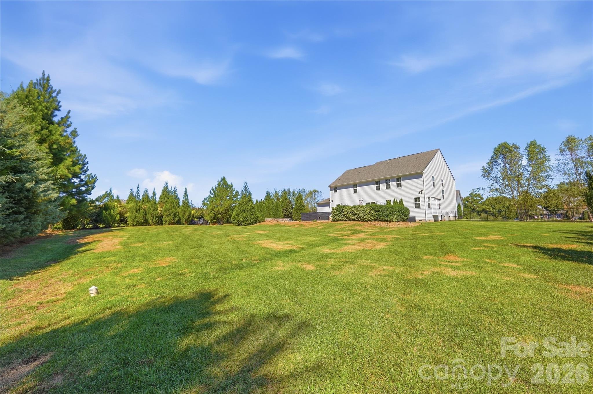 Expansive, fully fenced backyard on a 0.94-acre lot, with wide open lawn beyond the pool area and plenty of room to play, garden, or entertain. - 912 Manorwood Drive, Waxhaw