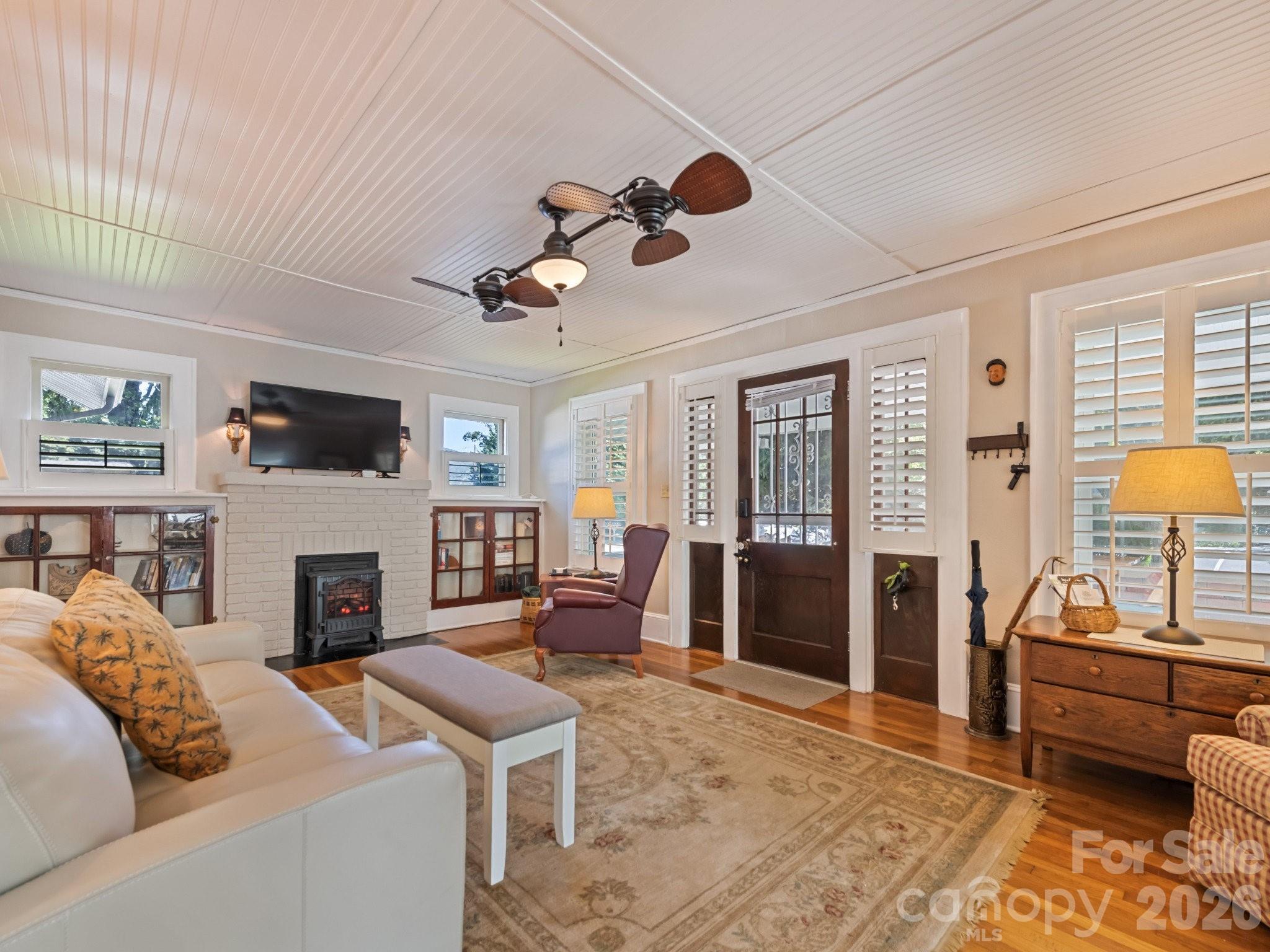 Living room with cozy electric insert - 50 Epsom Street, Waynesville