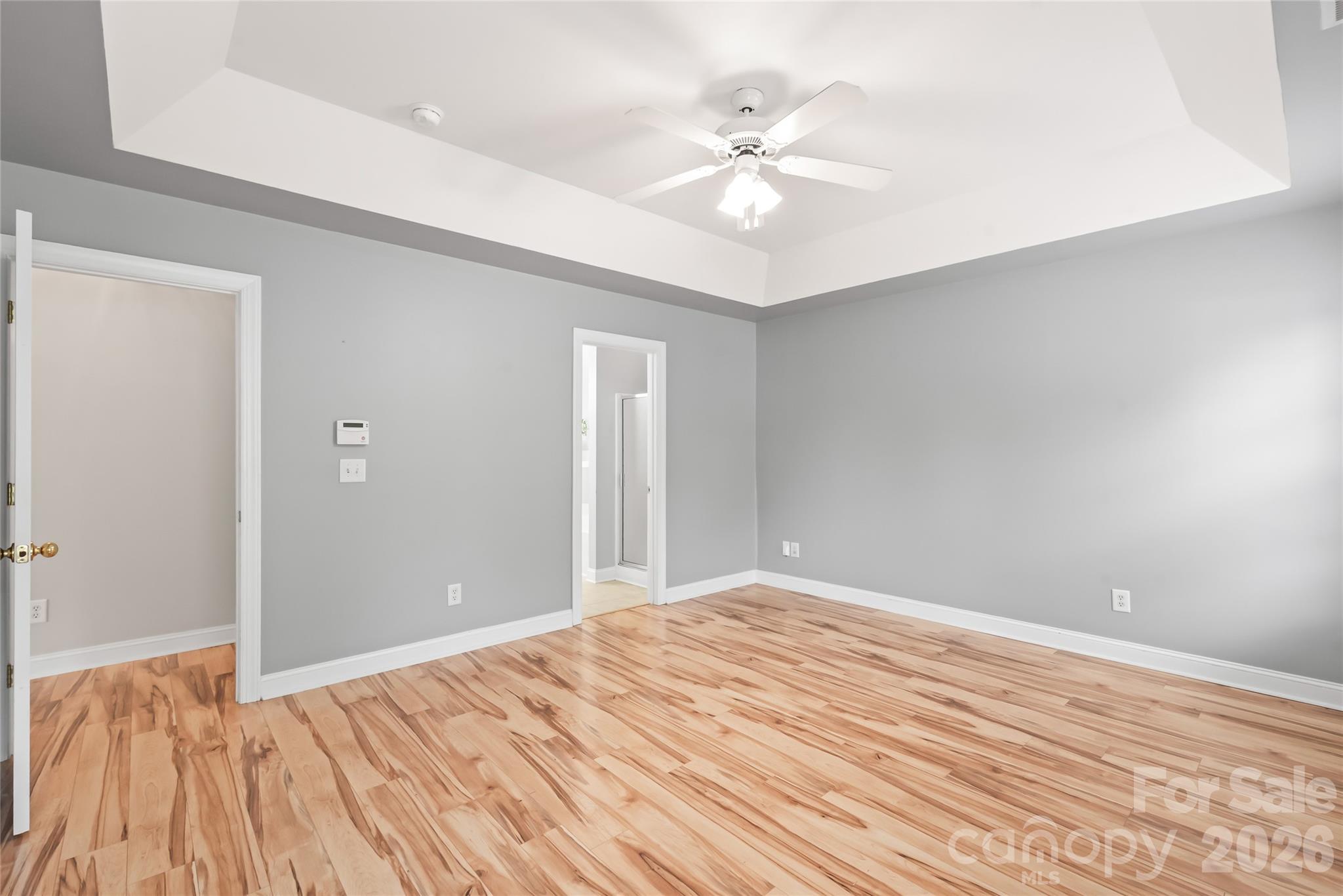Your personal daily retreat! The primary suite on the main level features a private spa-like ensuite, complete with a walk-in closet for effortless morning routines. - 2008 Trace Creek Drive, Waxhaw