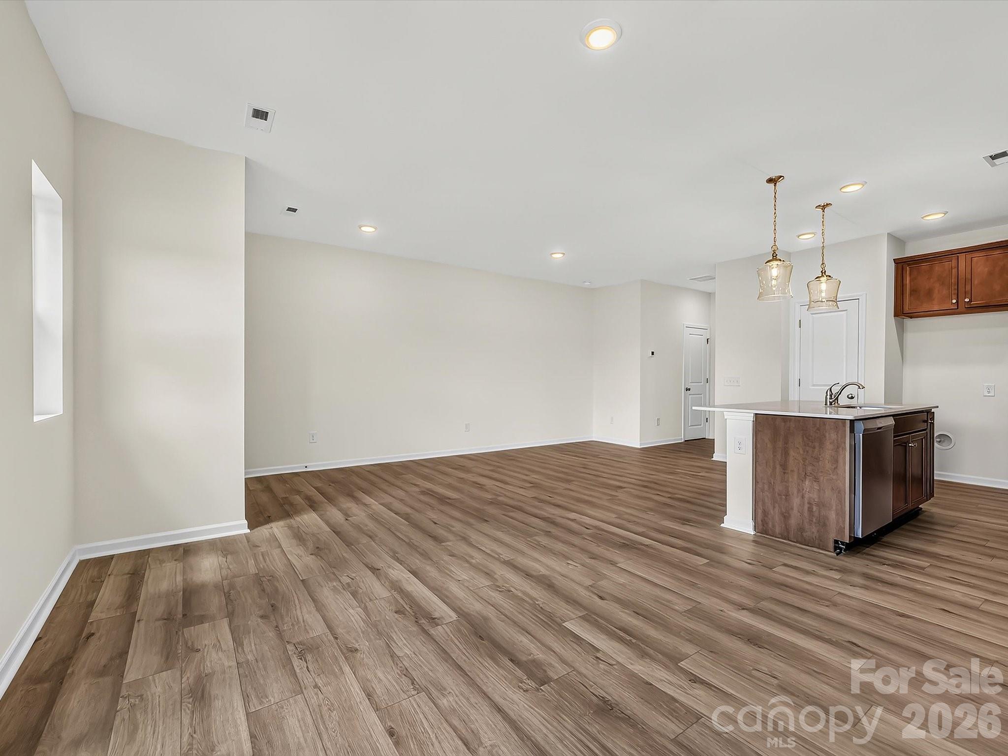 Family Room Open to Kitchen and Dining Area is Perfect for Entertaining Guests - 6565 Fire Lily Lane, Charlotte