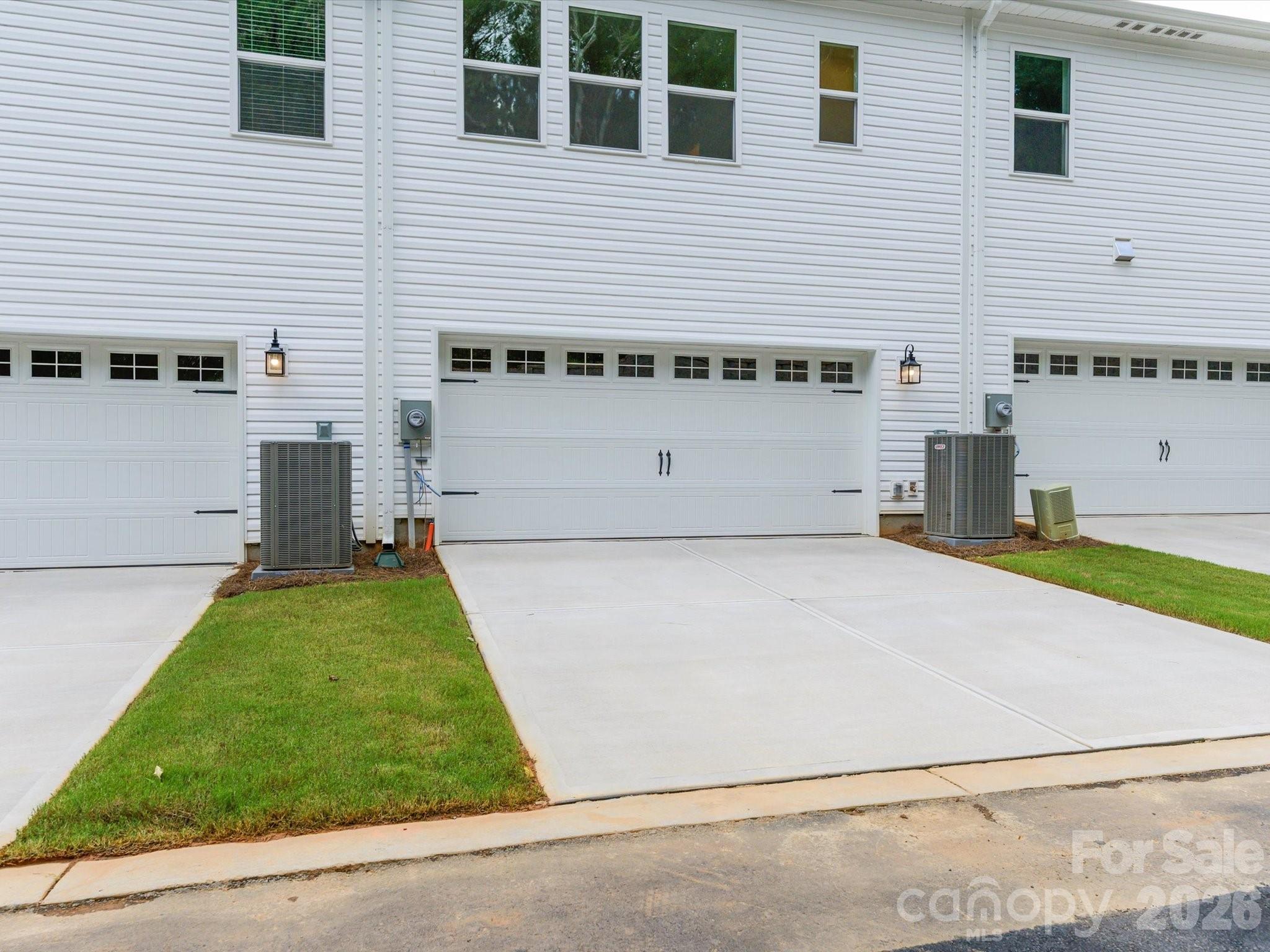 2 car side-by-side rear loading garage and 20 ft driveway offering parking for 4 vehicles - 6565 Fire Lily Lane, Charlotte