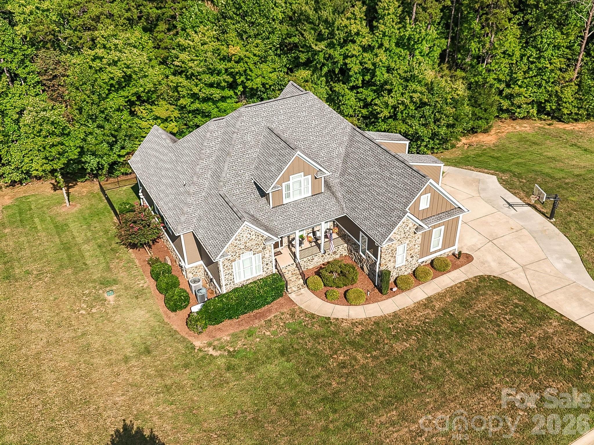 Aerial views showcase the home’s impressive setting on a spacious homesite surrounded by mature trees, expansive lawn, and a peaceful residential backdrop. - 3167 James Plantation Drive, Denver