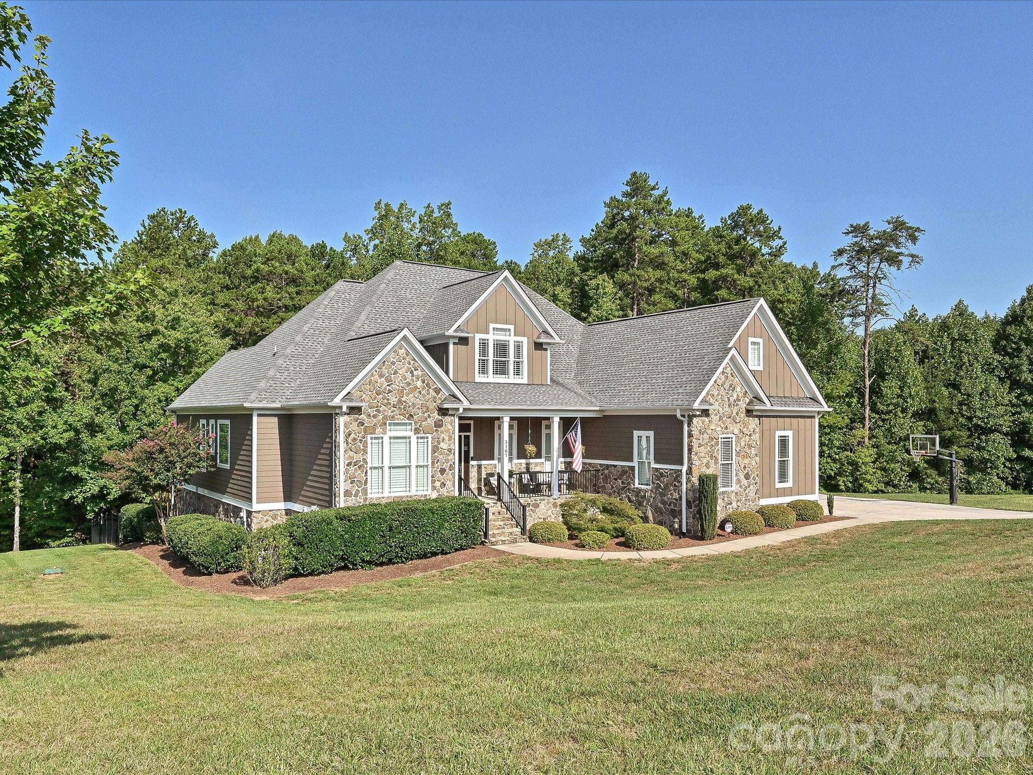 Wide views showcase the home’s impressive setting on a spacious homesite surrounded by mature trees, expansive lawn, and a peaceful residential backdrop. - 3167 James Plantation Drive, Denver