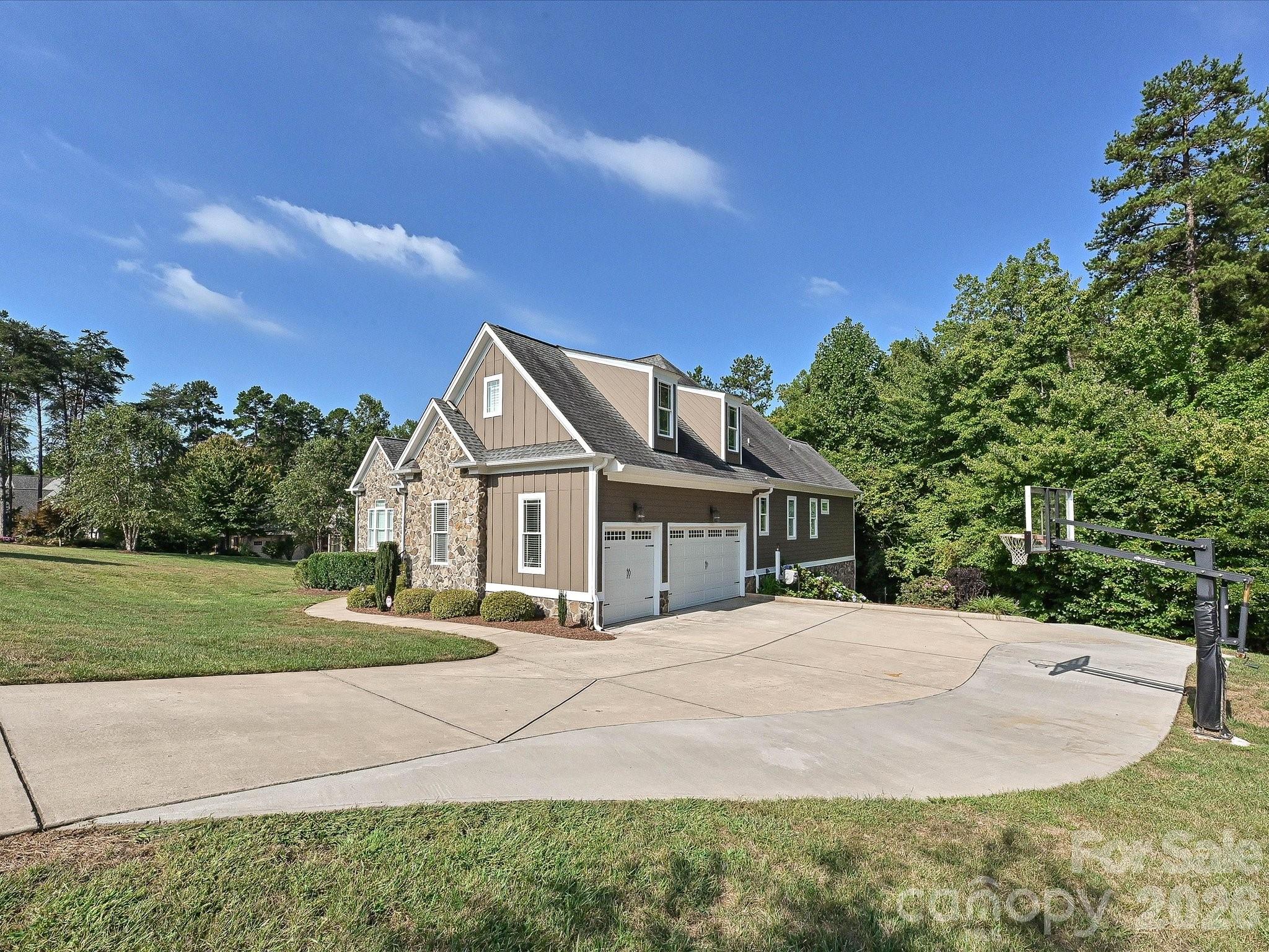Wide views showcase the home’s impressive setting on a spacious homesite surrounded by mature trees, expansive lawn, and a peaceful residential backdrop. - 3167 James Plantation Drive, Denver