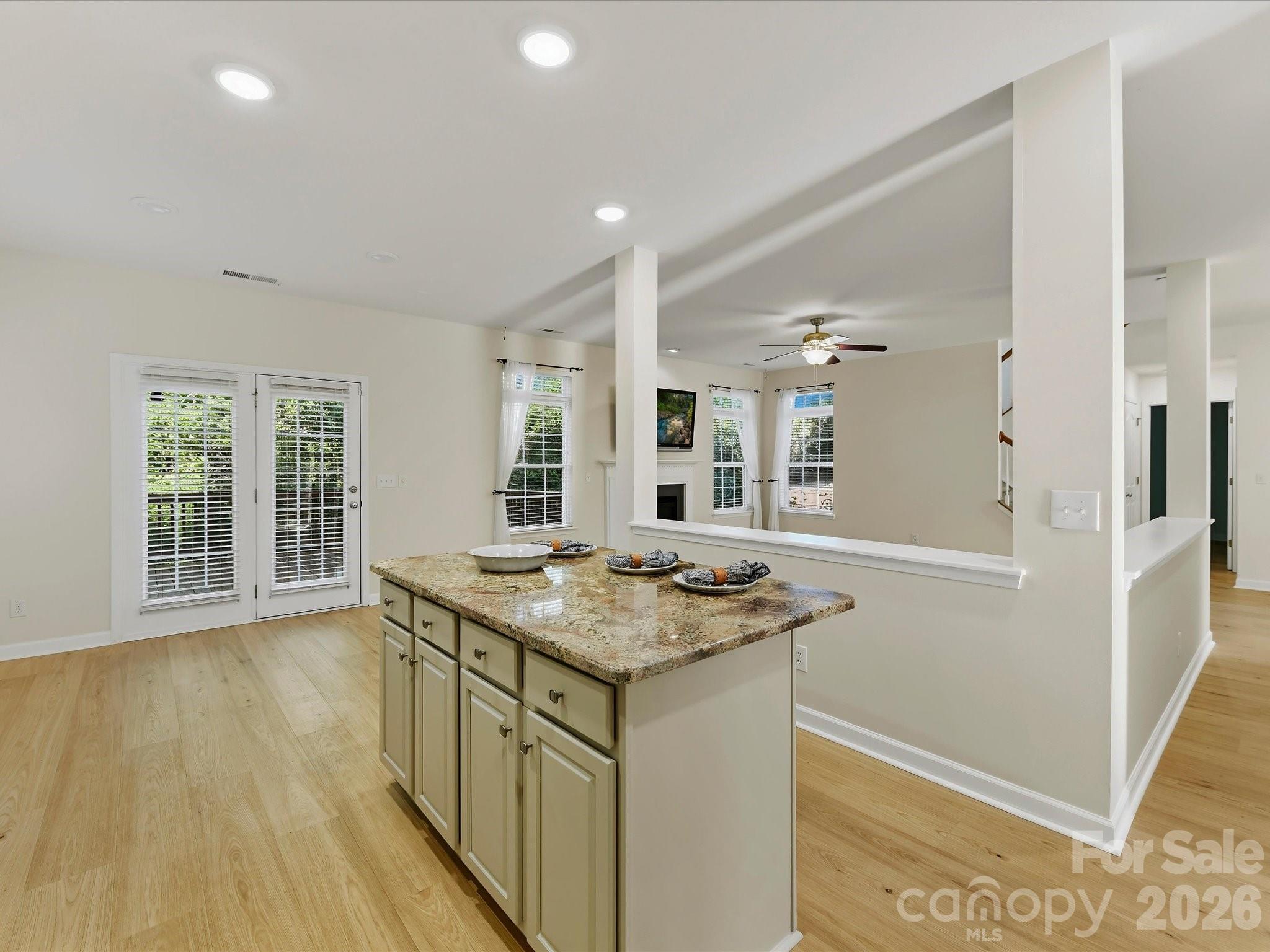 A center island features a breakfast bar - 8128 Madrigal Court, Waxhaw