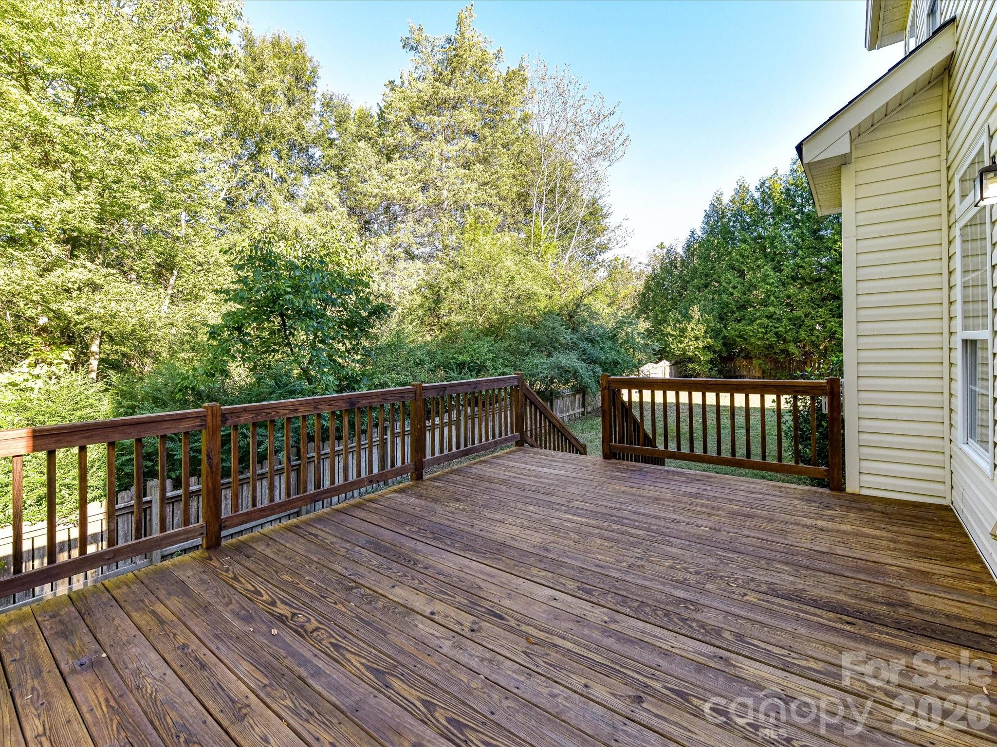 Recently stained deck is spacious and enjoys views of the setting sun. - 8128 Madrigal Court, Waxhaw