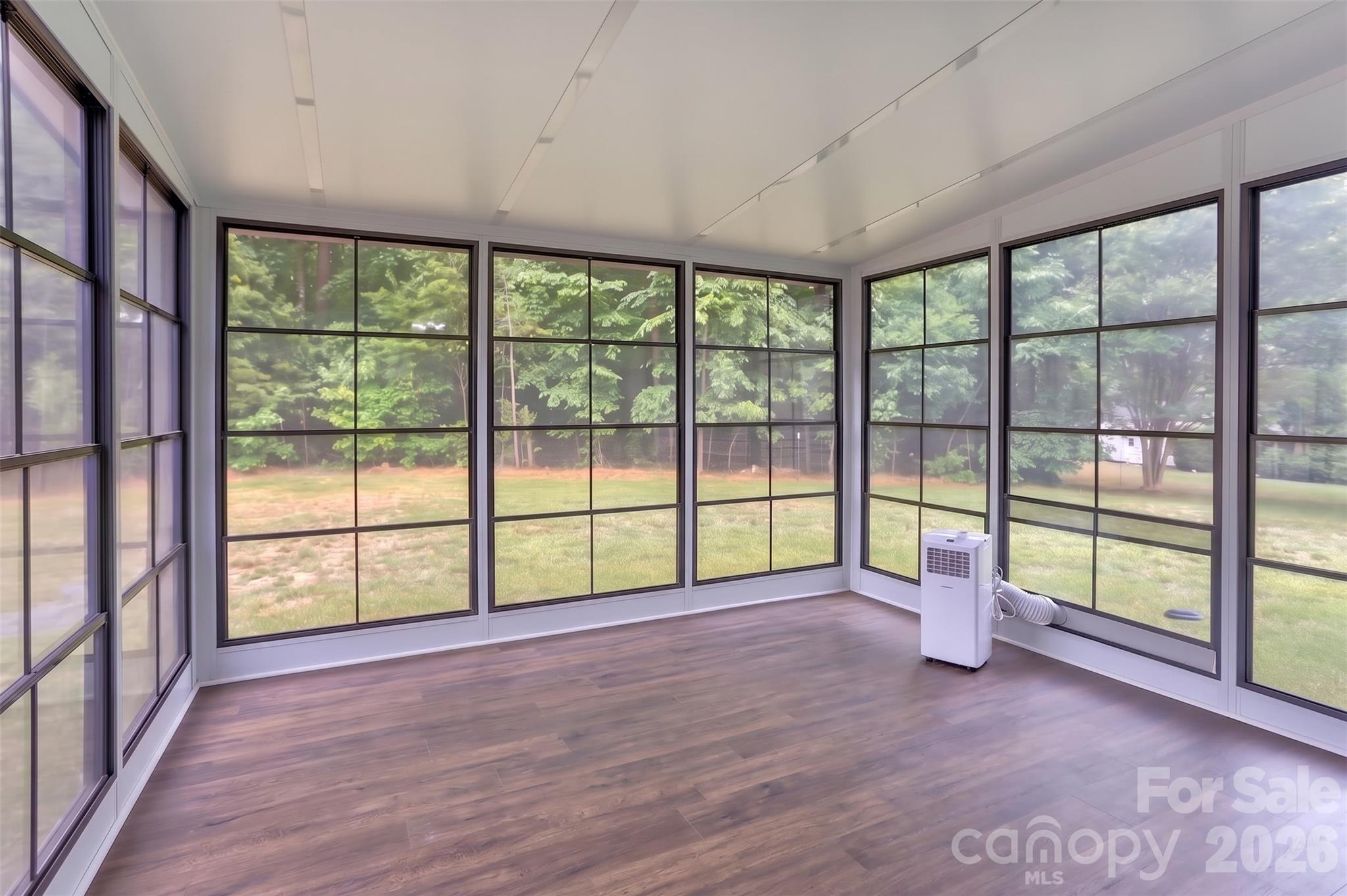 Highlight of the main level! Sunroom added in 2024 off the kitchen with portable AC unit and screens for cool, fall evenings. - 317 Oak Brook Drive, Salisbury