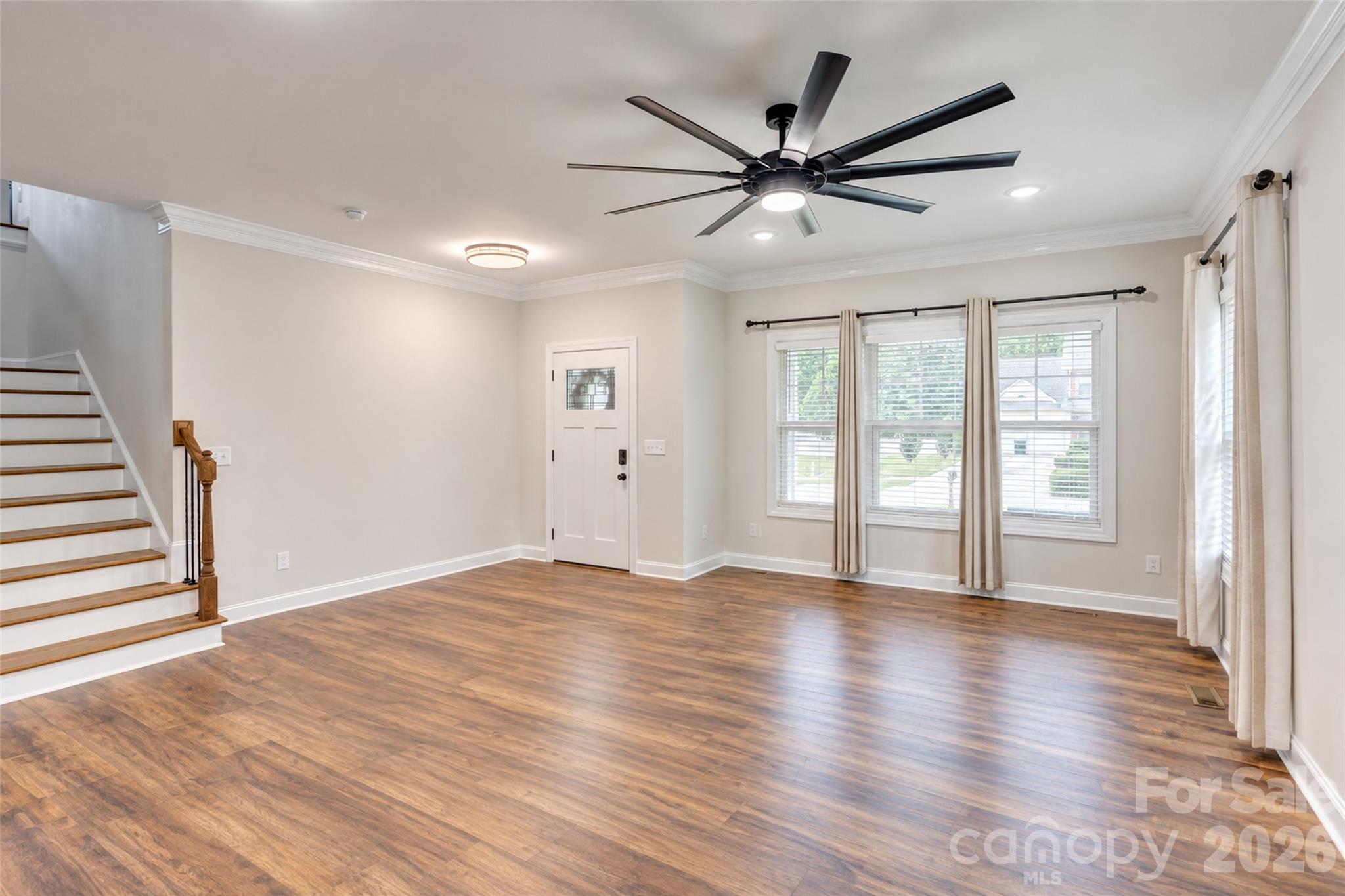 Large open living area opens up into foyer, kitchen, dining and leads to a hallway for pantry, dropzone, laundry, half bath and garage. - 317 Oak Brook Drive, Salisbury