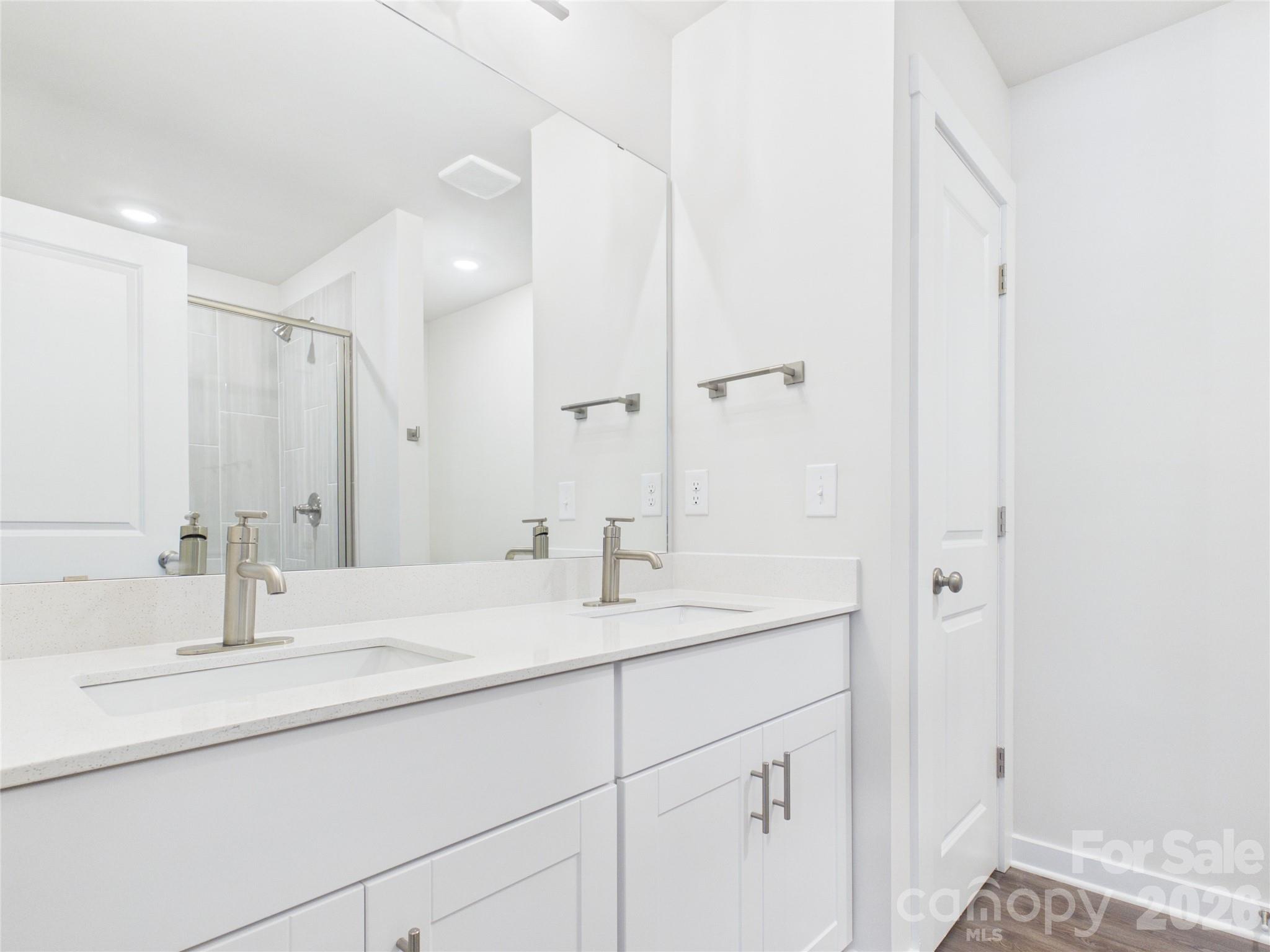 Hall bath with dual sinks and linen closet - 105 Dilling Street N, Kings Mountain