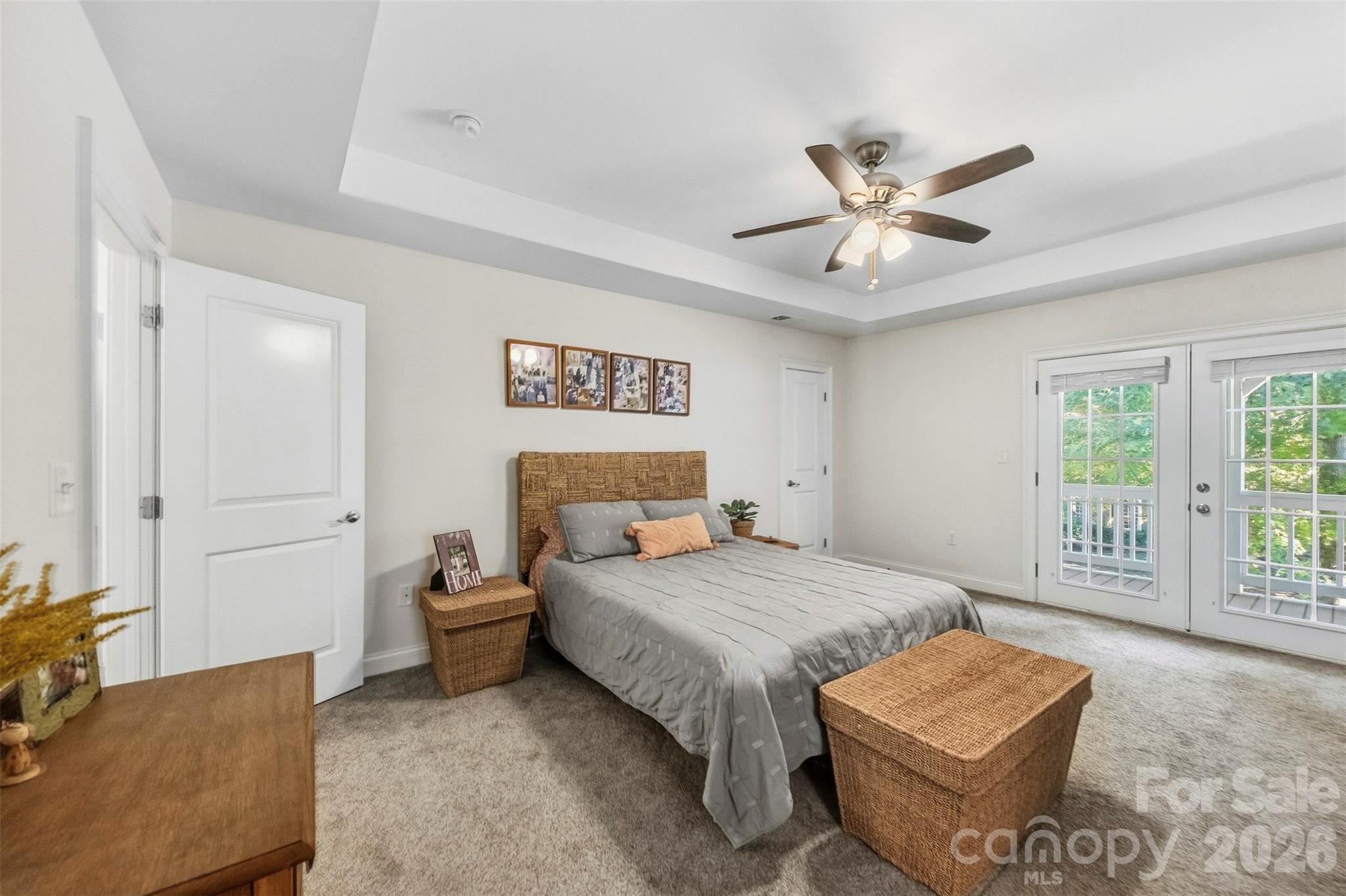 Primary bedroom with french doors out to the spacious covered patio - 109 Fulton Farms Lane, Mooresville