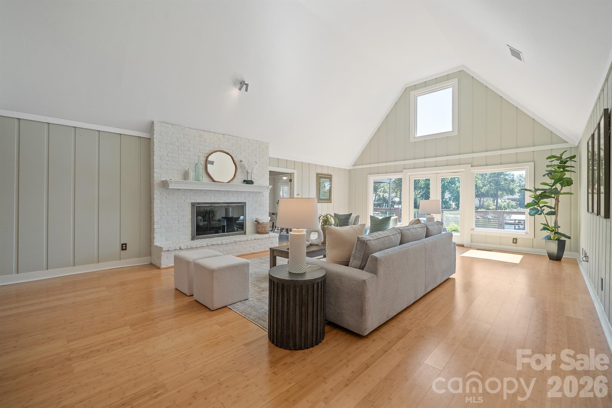 Gas log fp and french doors that lead to full upper deck on this ranch basement home - 20919 Island Forest Drive, Cornelius