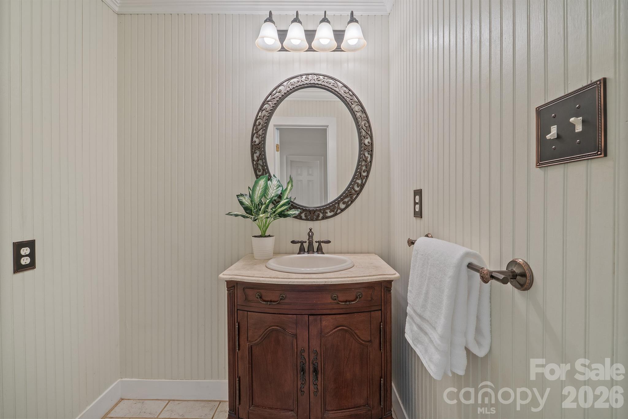 Powder bath has shiplap vertical walls and furniture piece vanity - 20919 Island Forest Drive, Cornelius