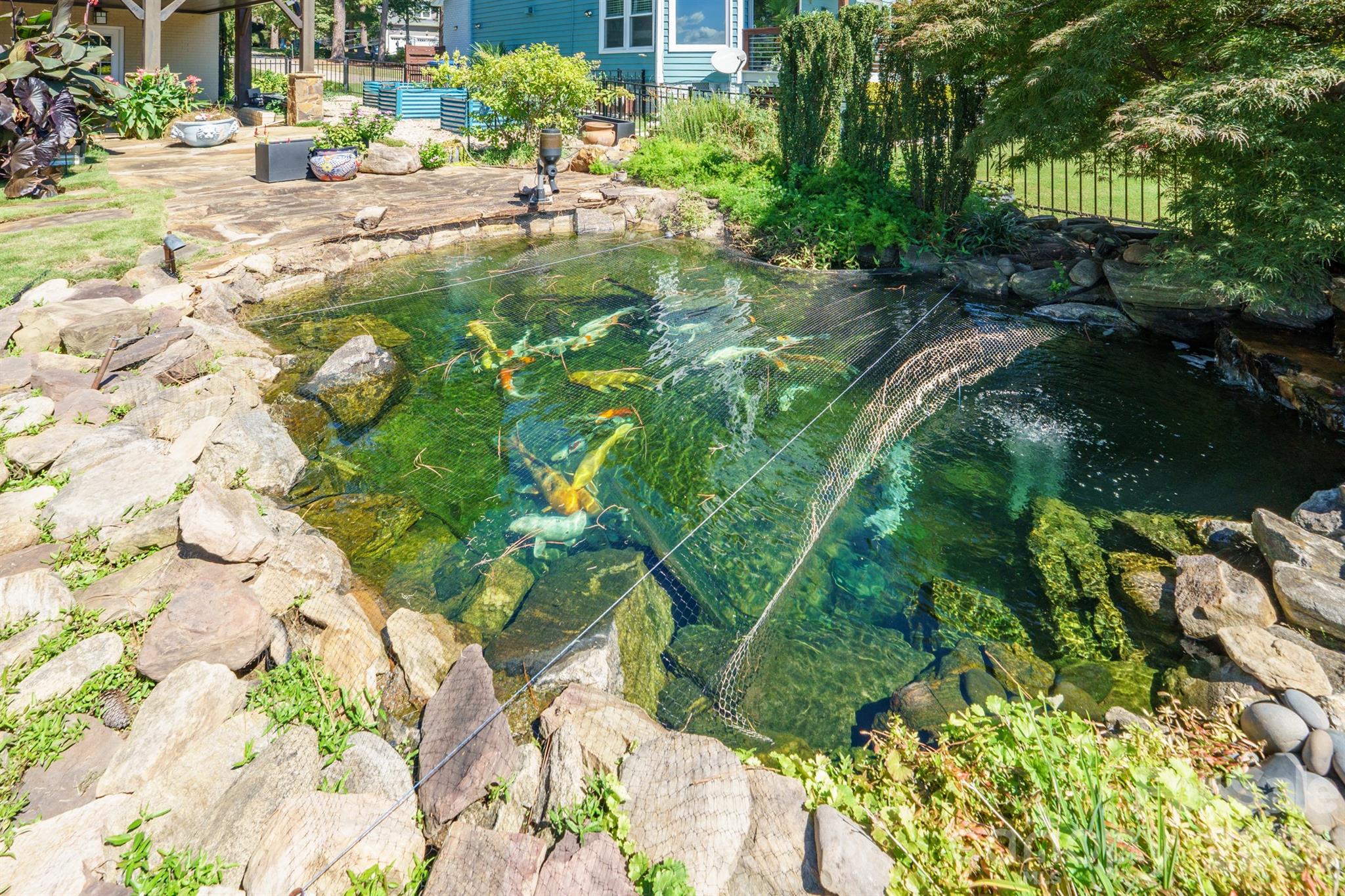 Auto feeder on this lovely zen KOI pond w night upligthing. Just another of the many outdoor spots to enjoy - 20919 Island Forest Drive, Cornelius