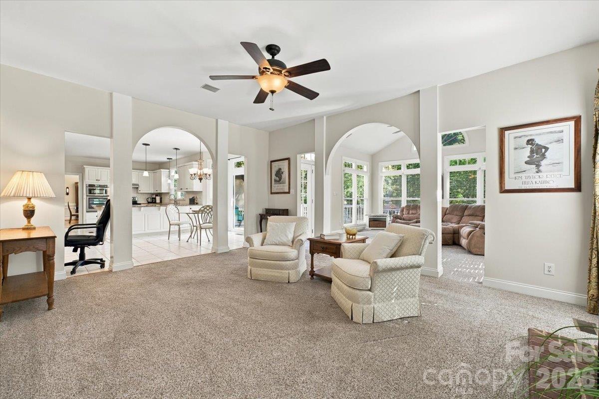 Large family room that flows into an open sunroom. - 178 Cove Creek Loop, Mooresville