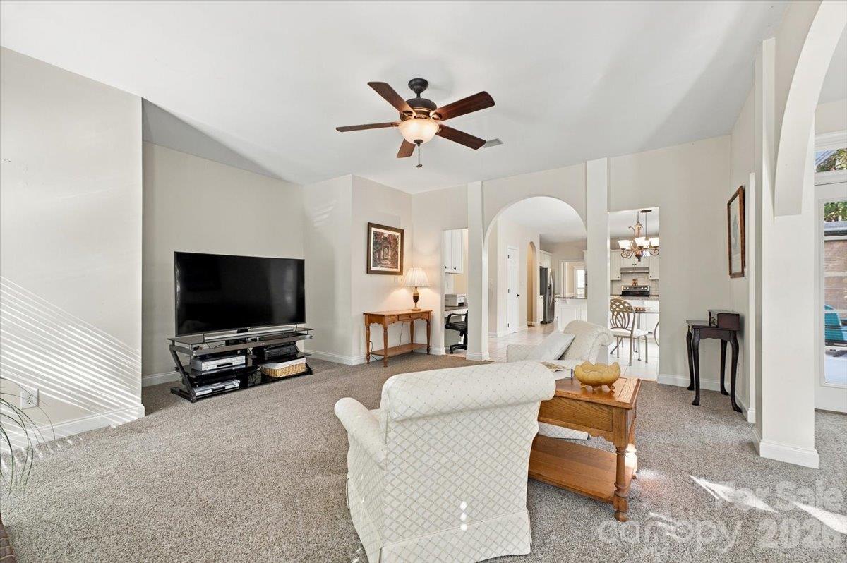 Large family room that flows into an open sunroom. - 178 Cove Creek Loop, Mooresville
