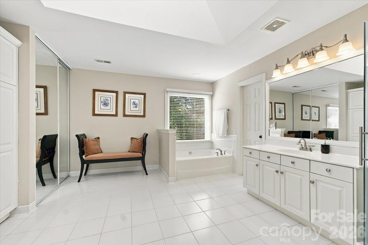 Lovely primary bath with lots of space and a skylight for extra light. - 178 Cove Creek Loop, Mooresville