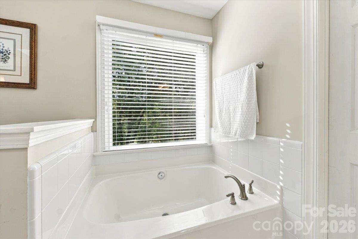 Lovely primary bath with lots of space and a skylight for extra light. - 178 Cove Creek Loop, Mooresville