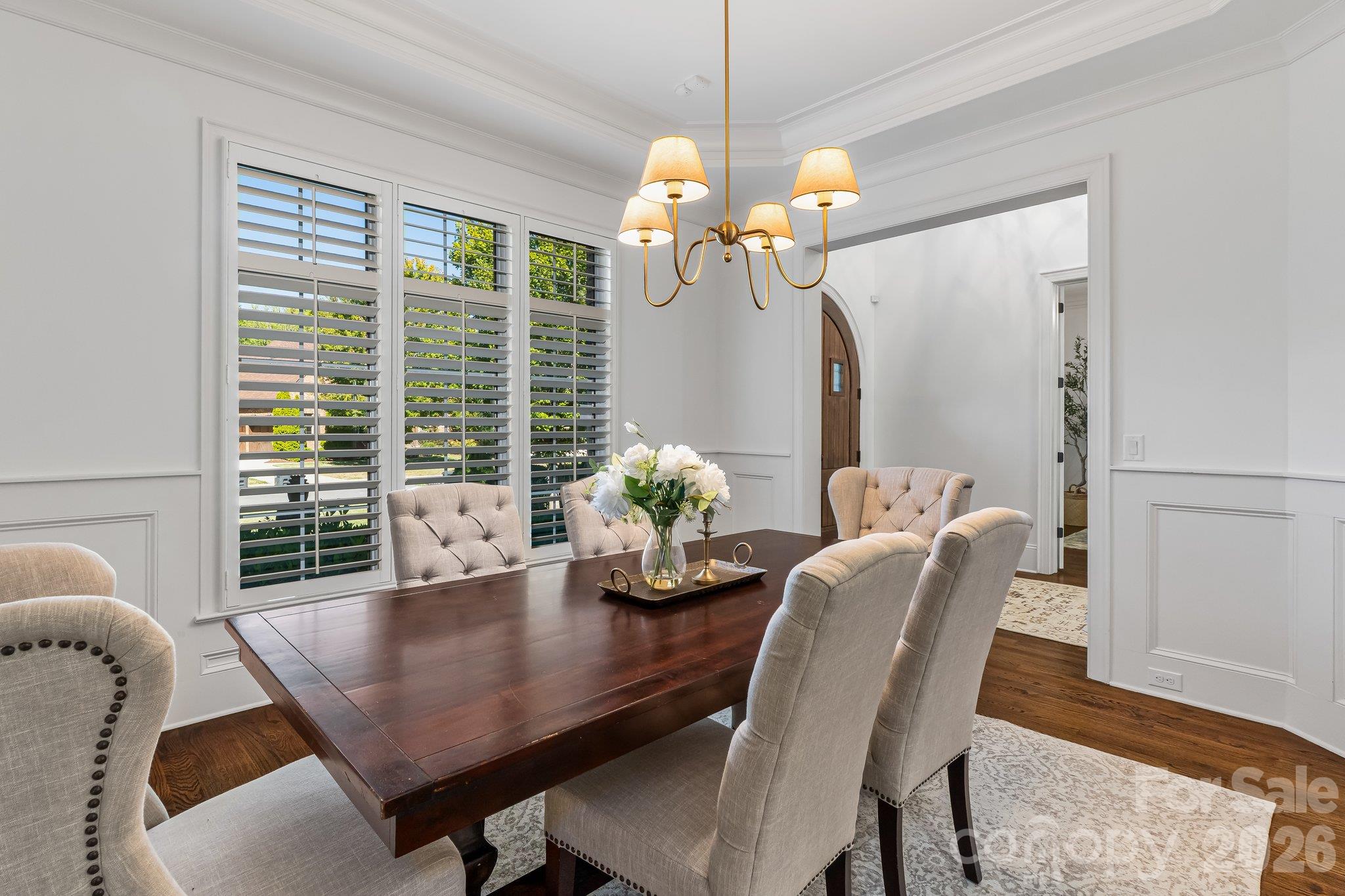 Elegant dining room w/waintscotting and new chandelier - 227 Glenmoor Drive, Waxhaw