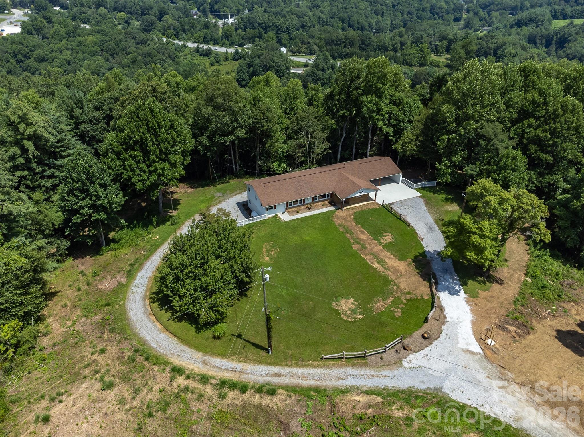 This view is showing the additional driveway to the lower level units - 468 Deer Park Lake Road, Spruce Pine