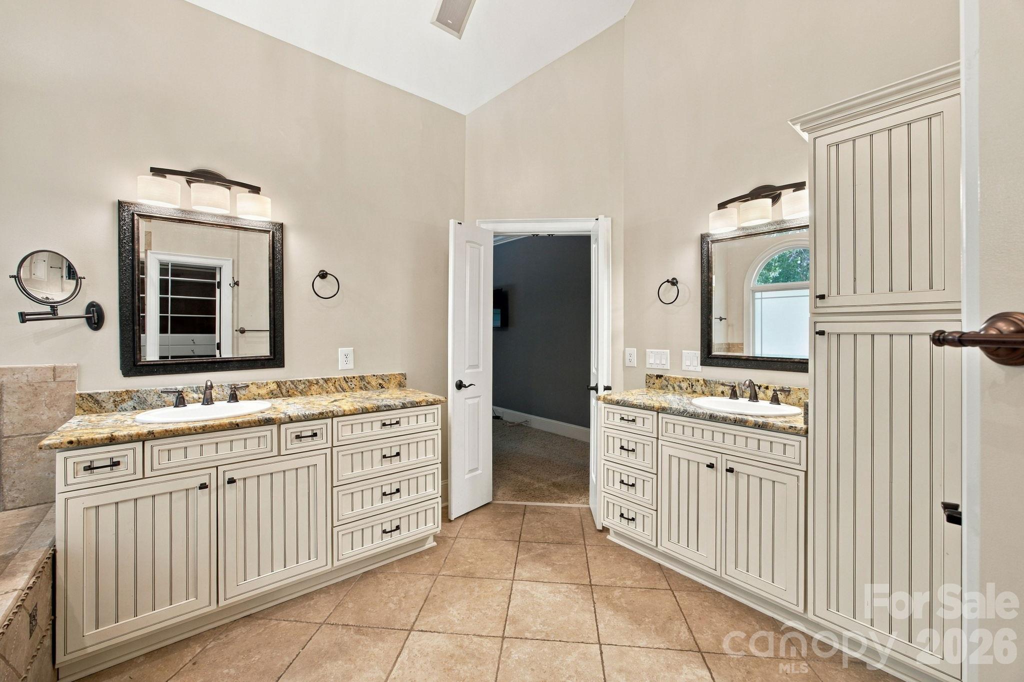 Custom cabinets and grantite counters in primary bath - 7481 Brotherton Road, Denver