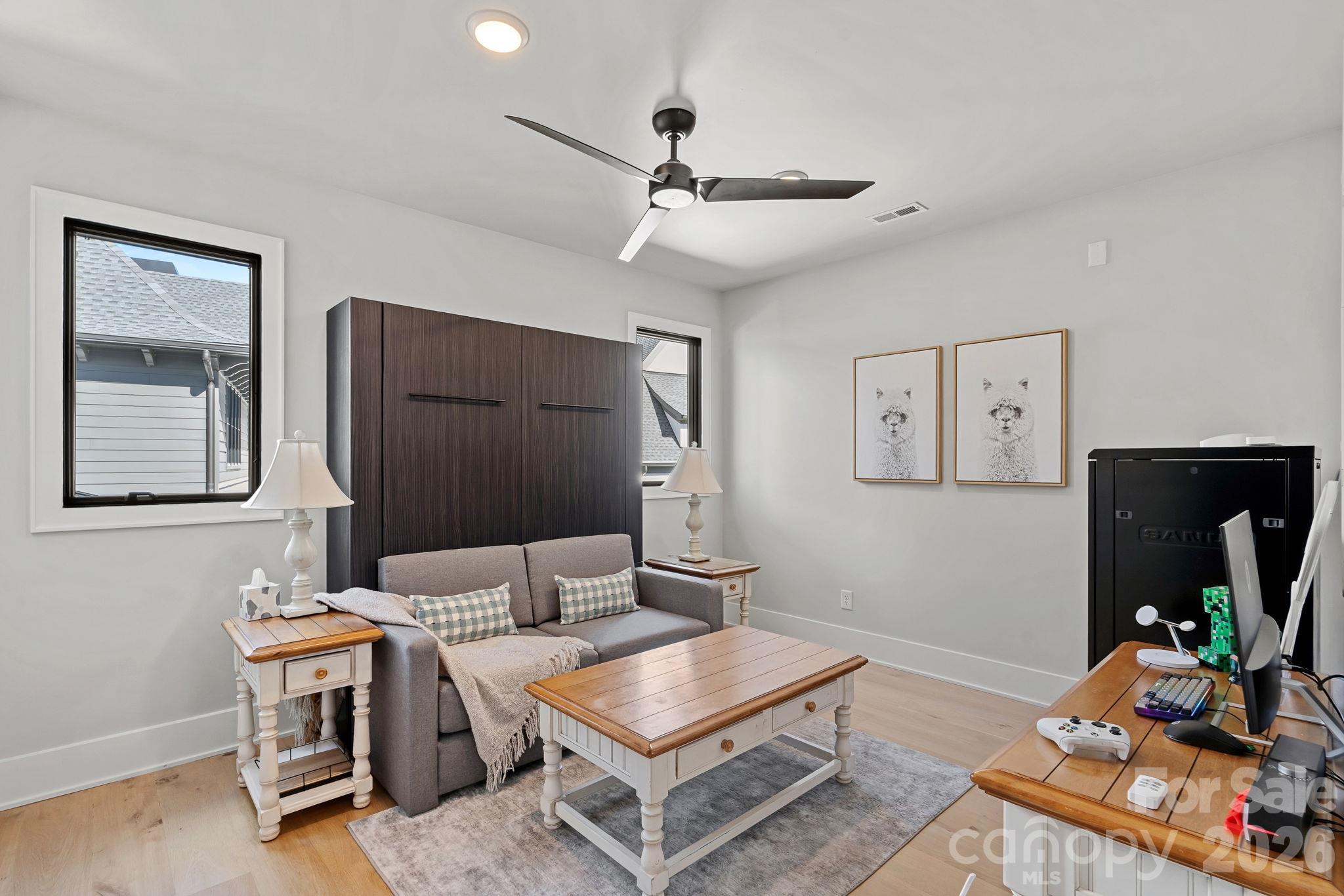 Versatile upper-level office with an integrated Murphy bed, offering effortless flexibility for overnight guests. - 17811 Largo Place, Cornelius