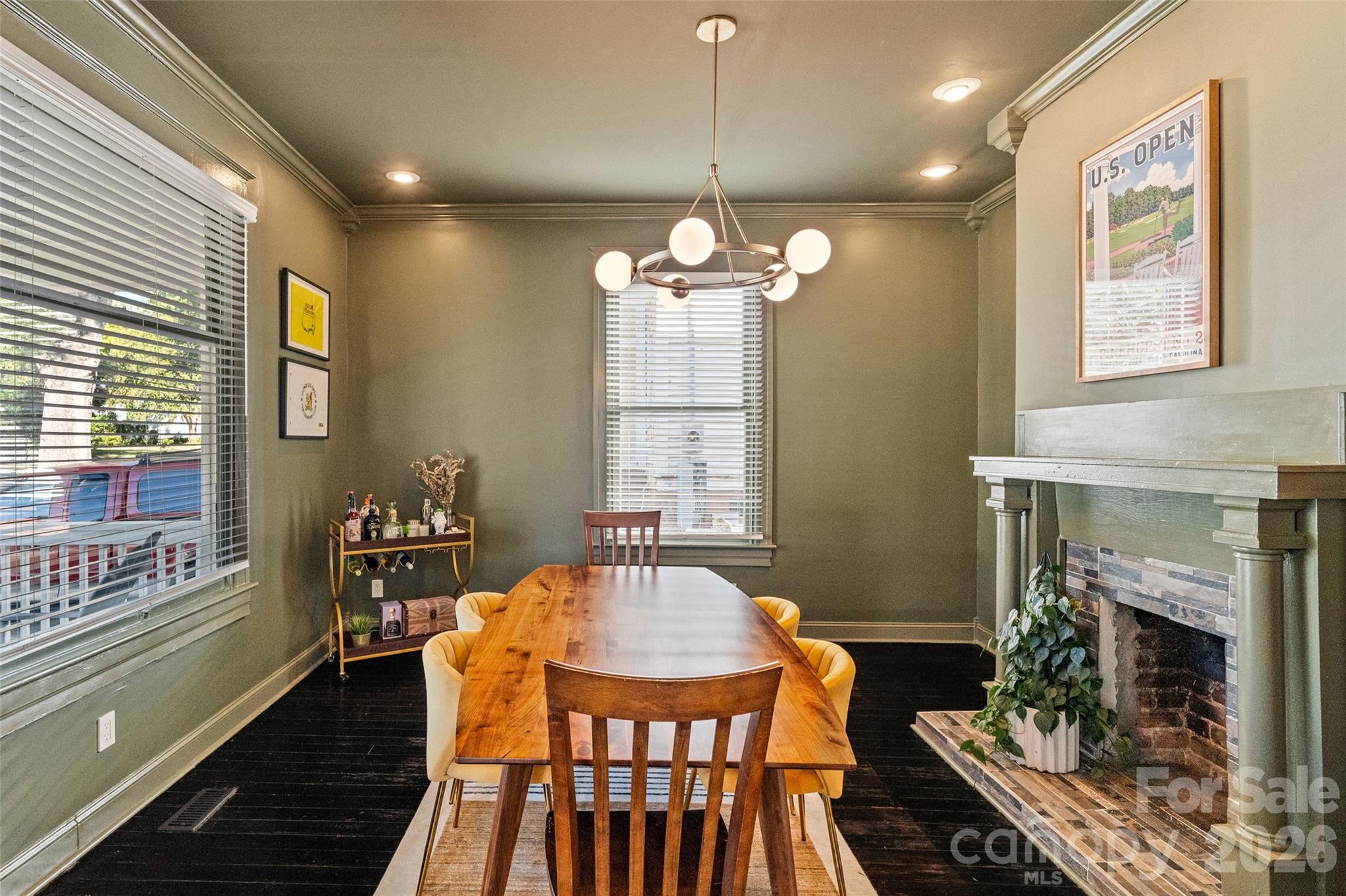 Color-drenched in Sherwin-Williams Sage Green Light, with a fireplace anchoring the dining room - 233 Marion Street, Rock Hill