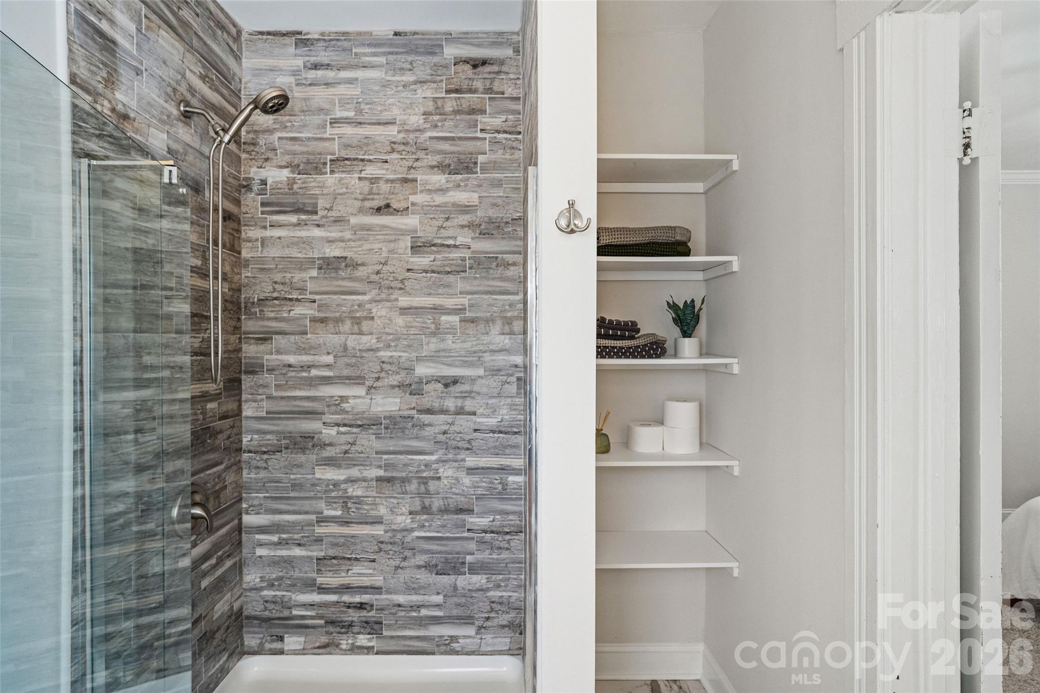 Primary ensuite with a tiled walk-in shower and built-in linen storage - 233 Marion Street, Rock Hill