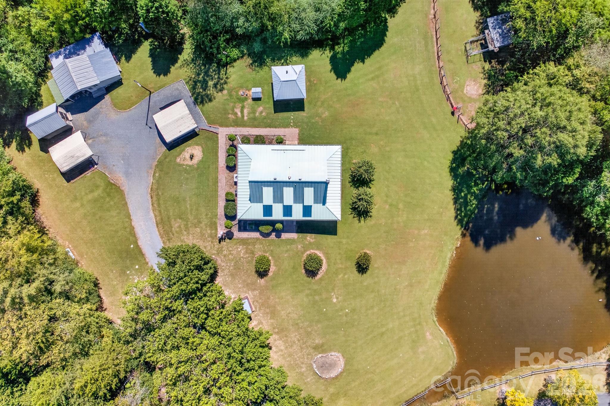 View showing the stocked pond next to the house. - 9702 Quail Cove Court, Indian Trail