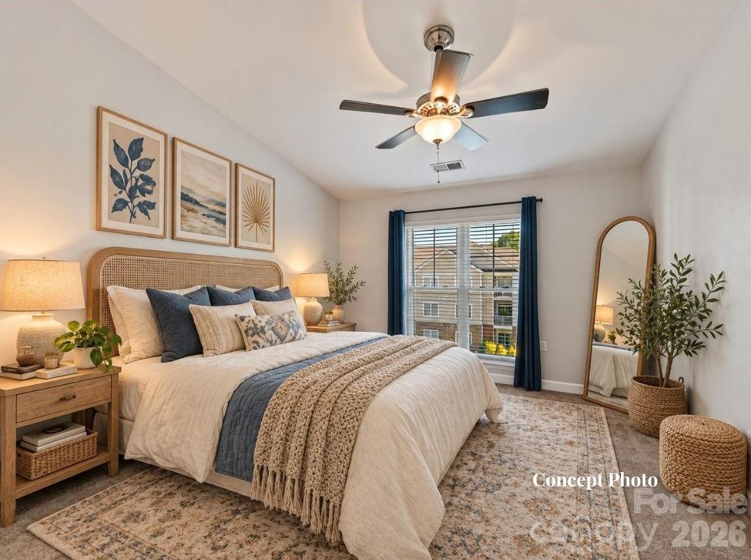 Virtually staged Spacious primary suite featuring plush carpeting, a ceiling fan, and a large window providing abundant natural light and elevated community views. - 9031 Mcdowell Creek Court, Cornelius