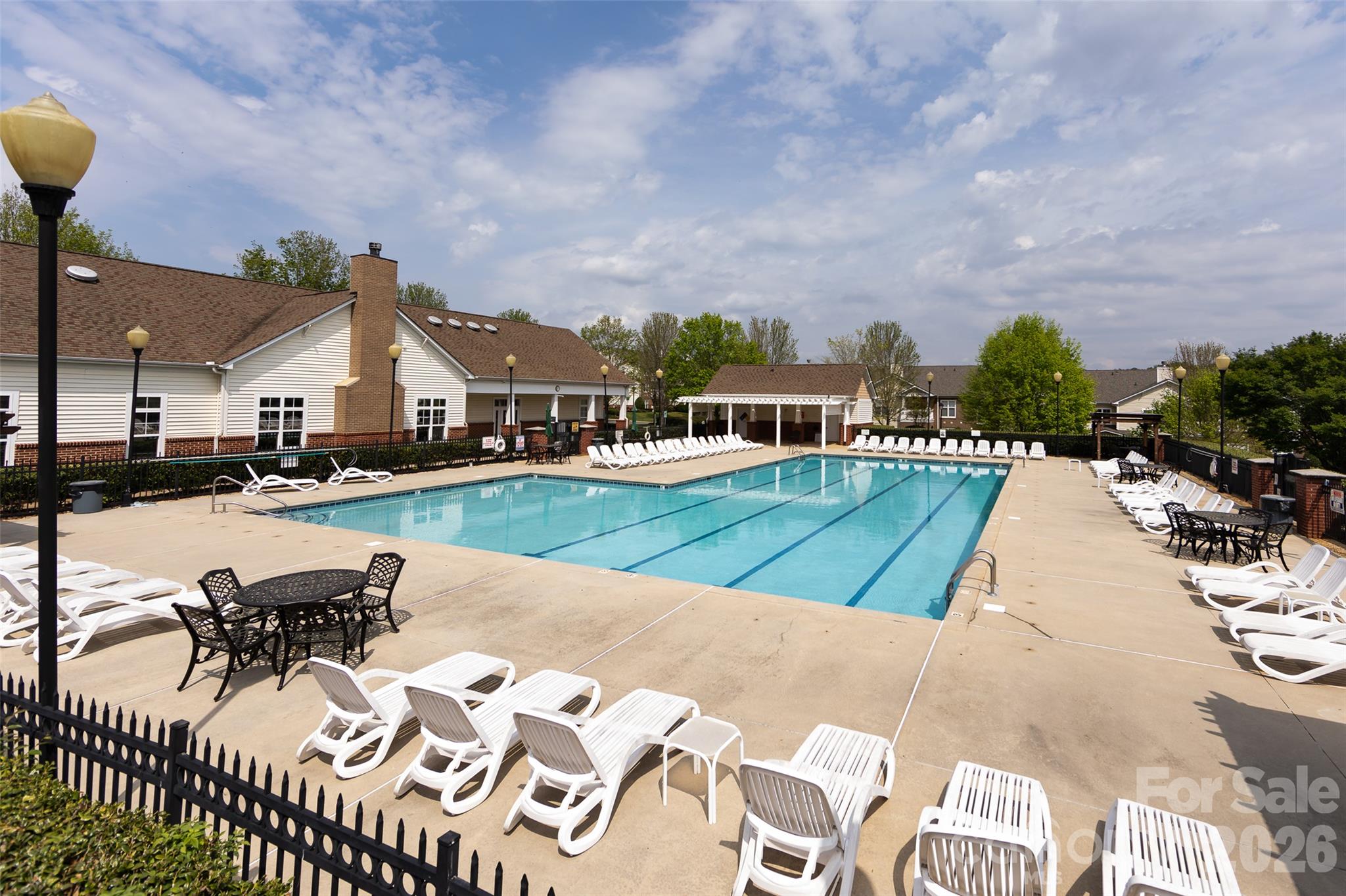 Community amenities include a spacious outdoor swimming pool with abundant lounge seating and a welcoming poolside setting for relaxing and recreation. - 9031 Mcdowell Creek Court, Cornelius