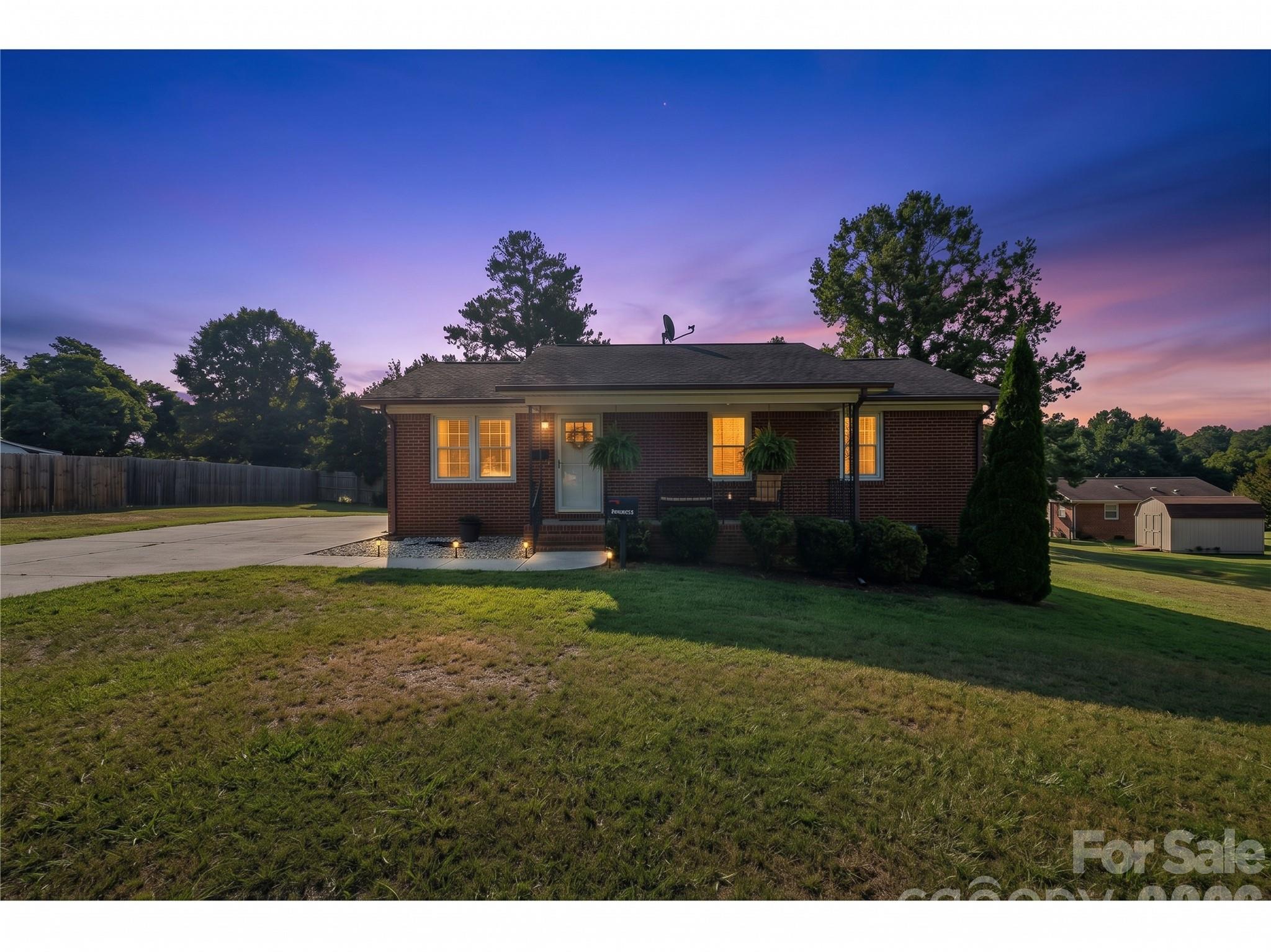 AI-Twilight view of the front of home fully fenced in yard - 645 Pine Ridge Road, Chester