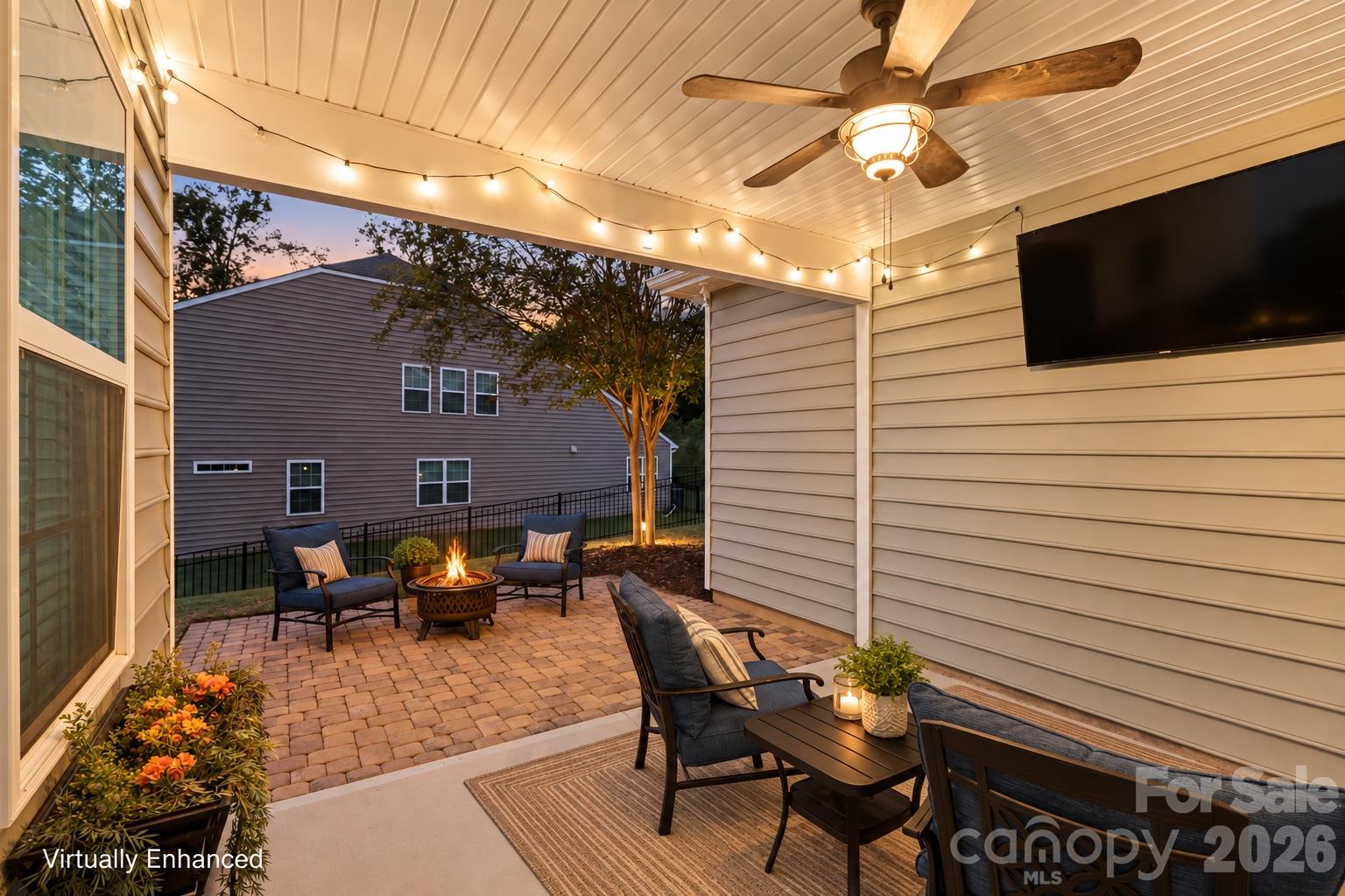 A backyard made for cozy nights by the fire pit, weekend gatherings, and relaxing under the covered patio. - 2003 Harvest Time Lane, Waxhaw