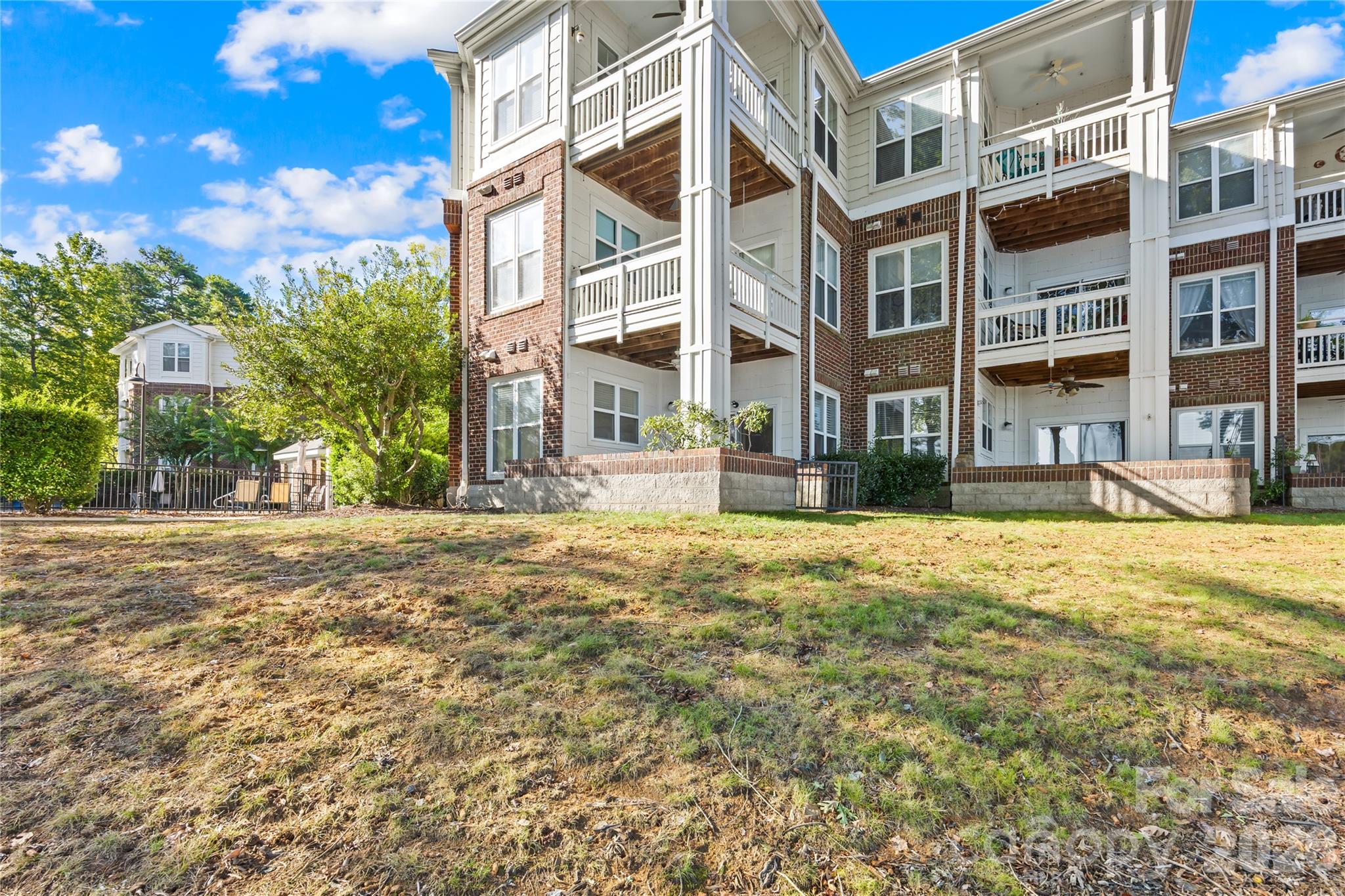 Located at the farthest, ground corner of the building with additional windows for tons of sunlight and water views! Easy access to the community waterfront pool! - 915 Northeast Drive, Davidson